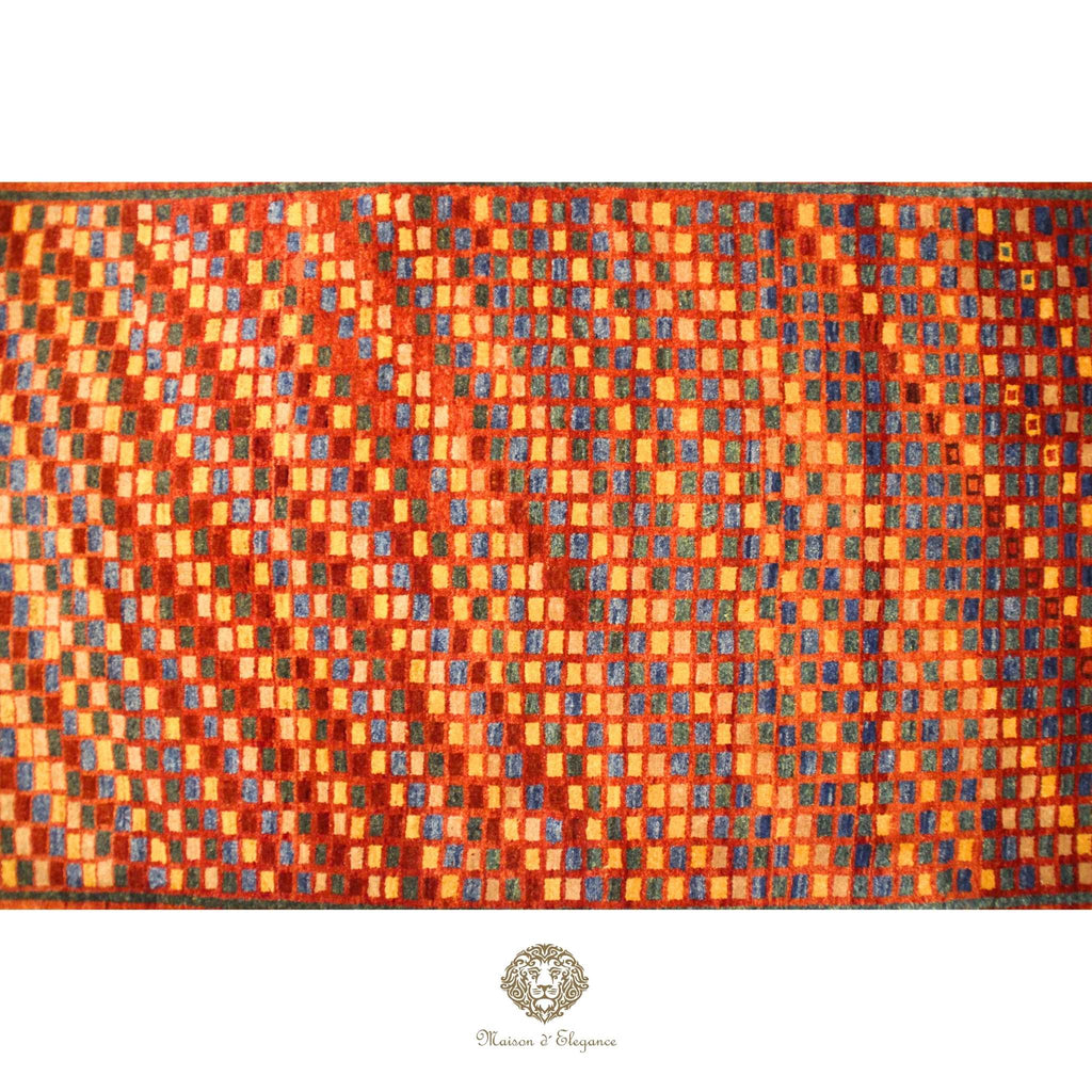 Patterned fabric with orange and blue squares on a red background