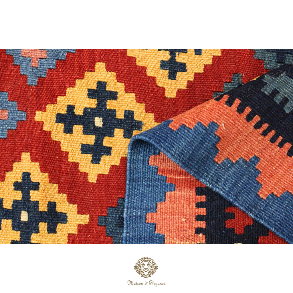 Close-up of a colorful patterned rug with geometric designs.