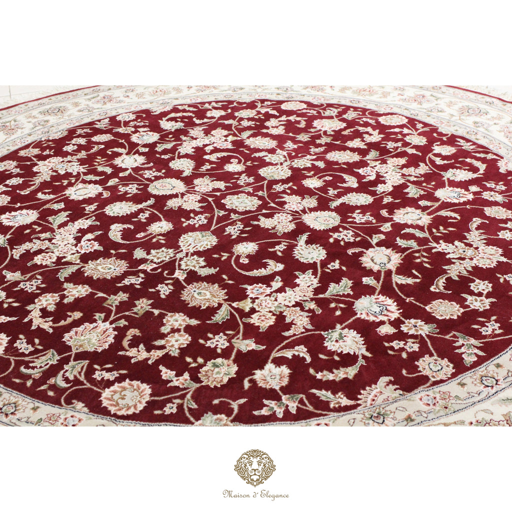 Round floral-patterned rug with red and beige colors on a red background