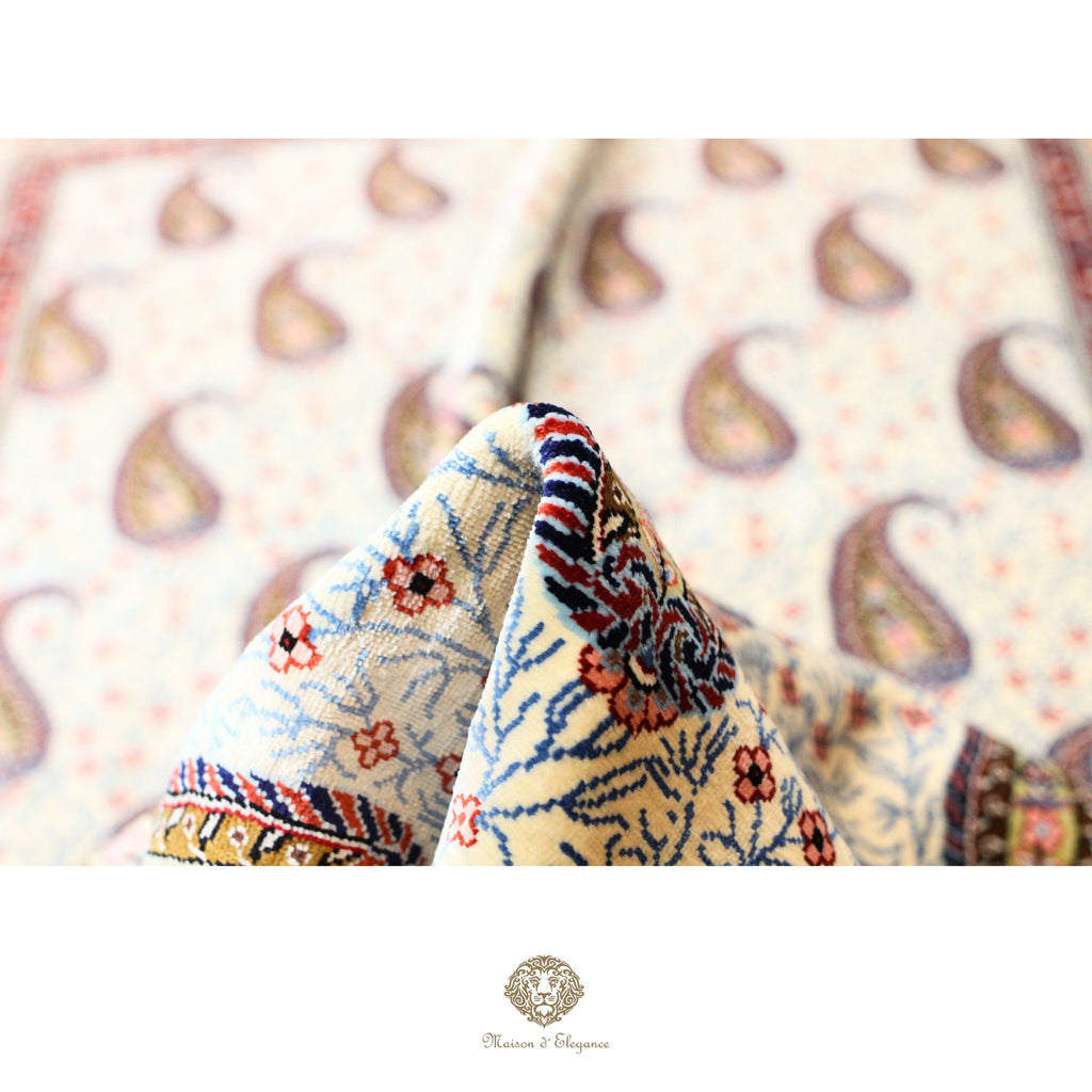 Close-up of patterned fabric with a blurred paisley design in the background