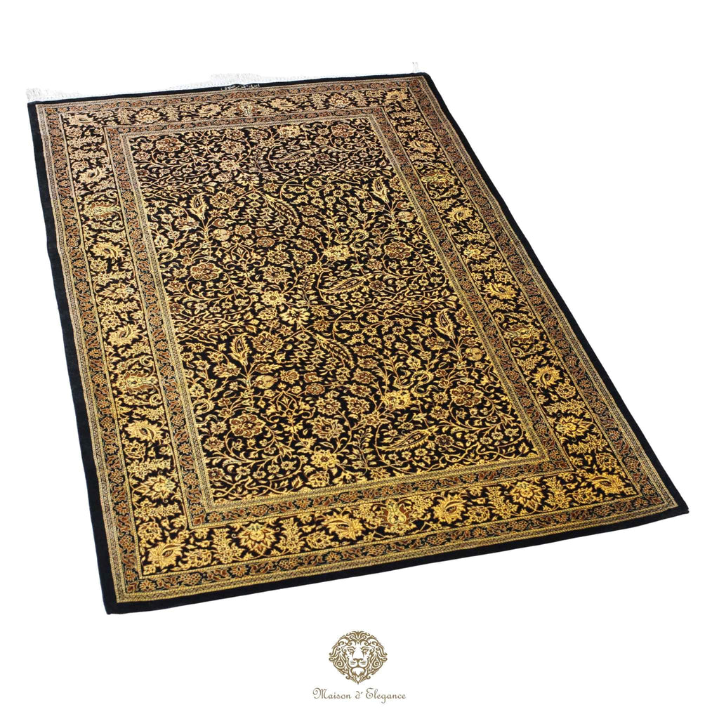 Decorative rug with intricate gold patterns on a black background