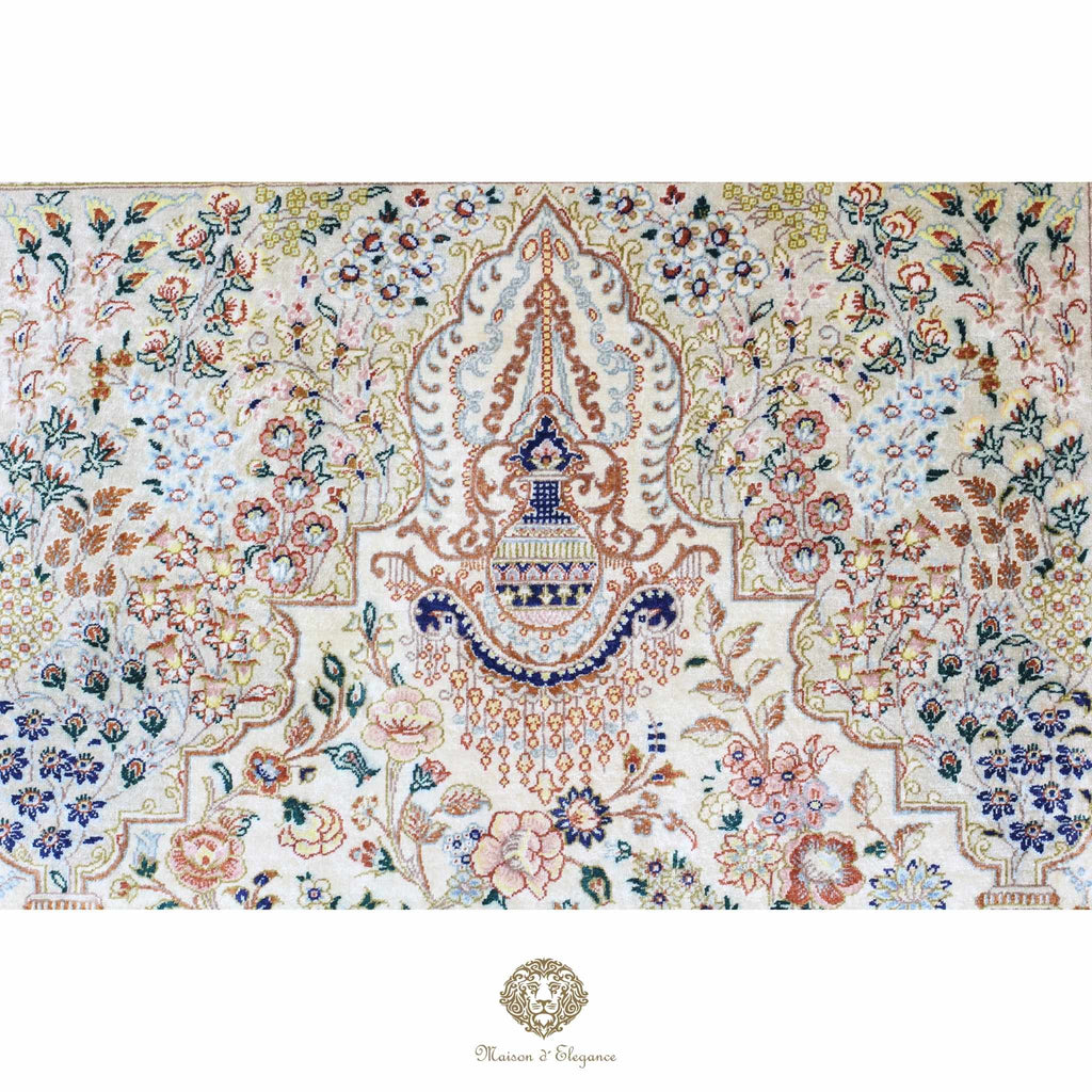 Decorative rug with intricate patterns and colors on a ivory background