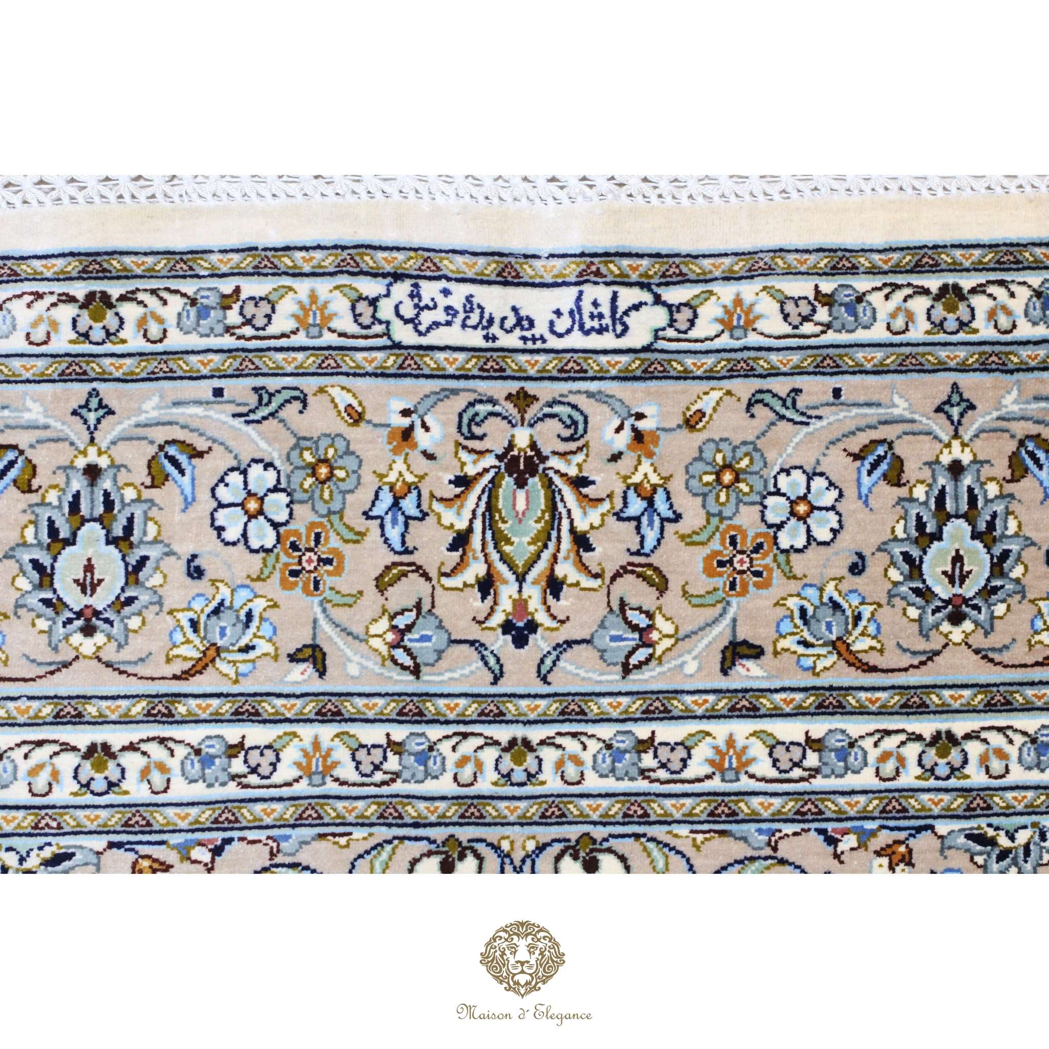 Close-up of a patterned rug with intricate designs and text.