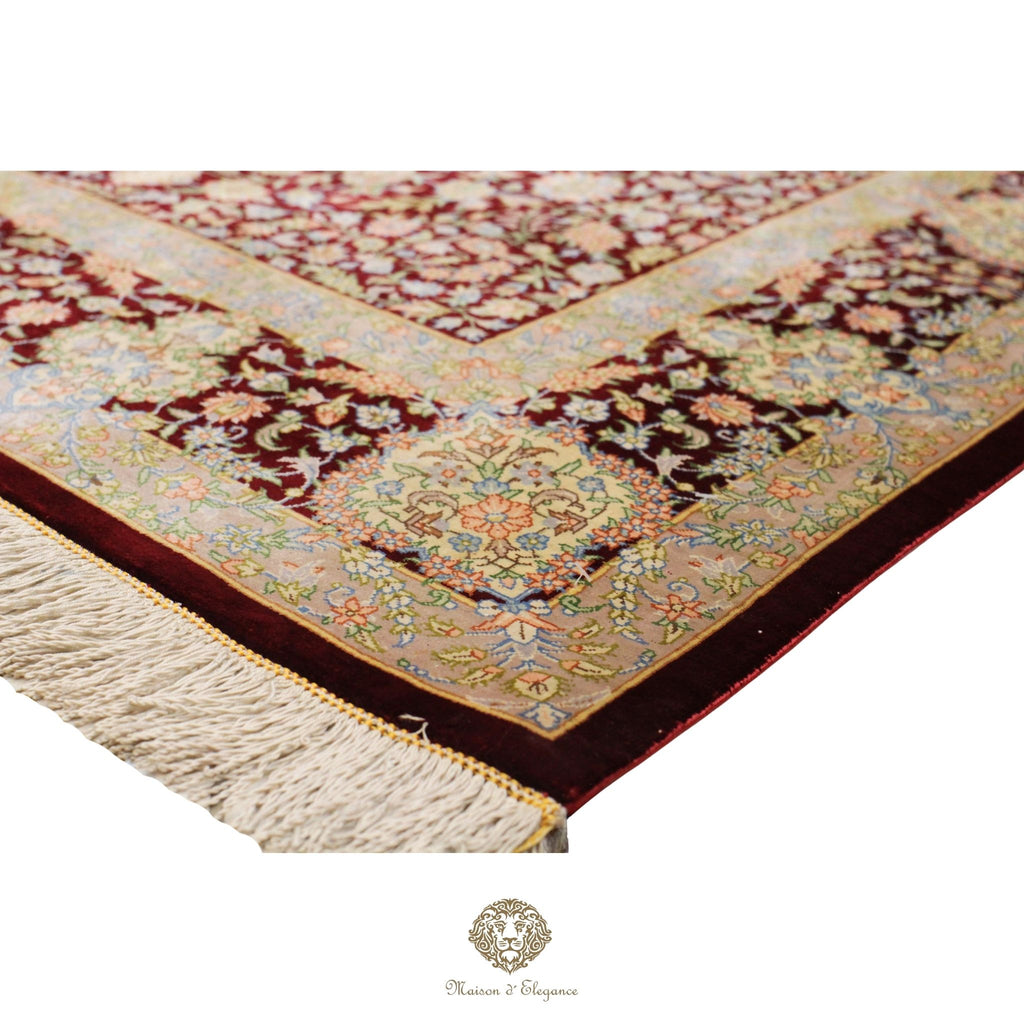 Decorative rug with intricate patterns and fringes on a white background