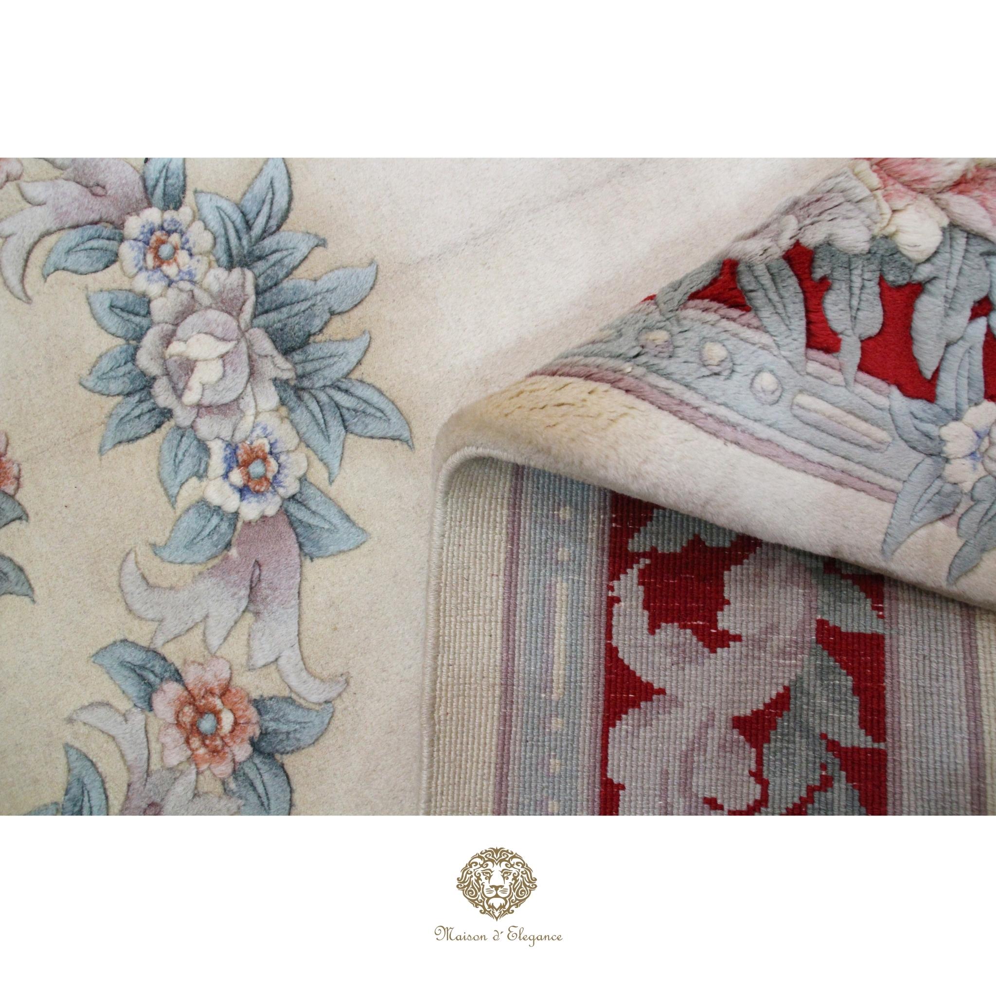 Close-up of a floral-patterned fabric with a brand logo at the bottom.