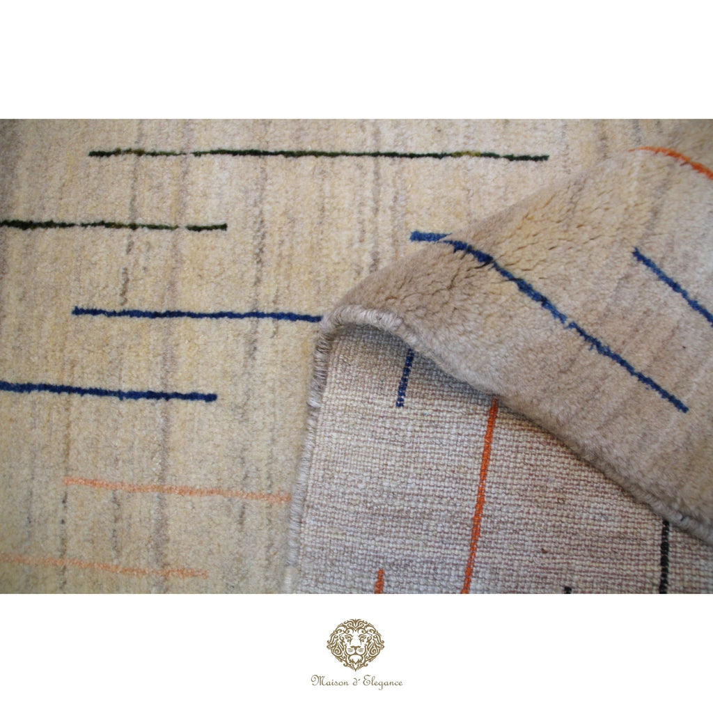 Close-up of a textured rug with geometric pattern and brand logo at the bottom.
