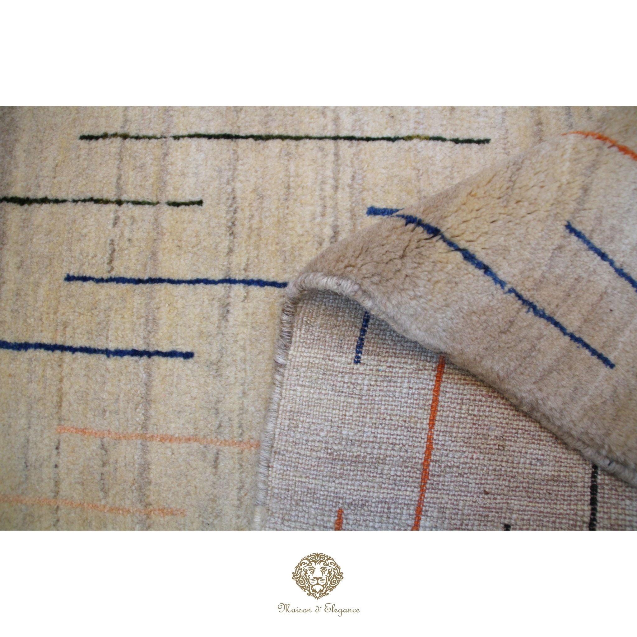 Close-up of a textured rug with geometric pattern and brand logo at the bottom.