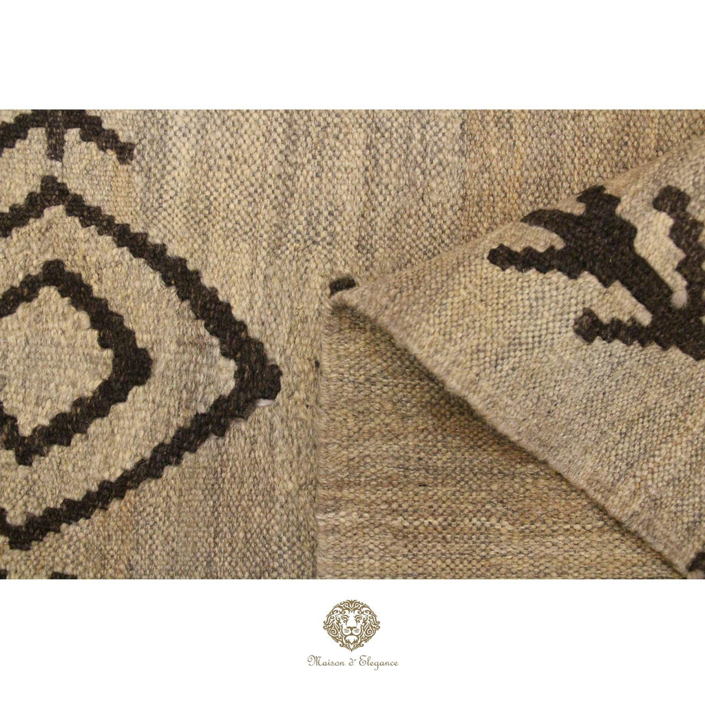 Close-up of a textured rug with geometric patterns on a ivory background
