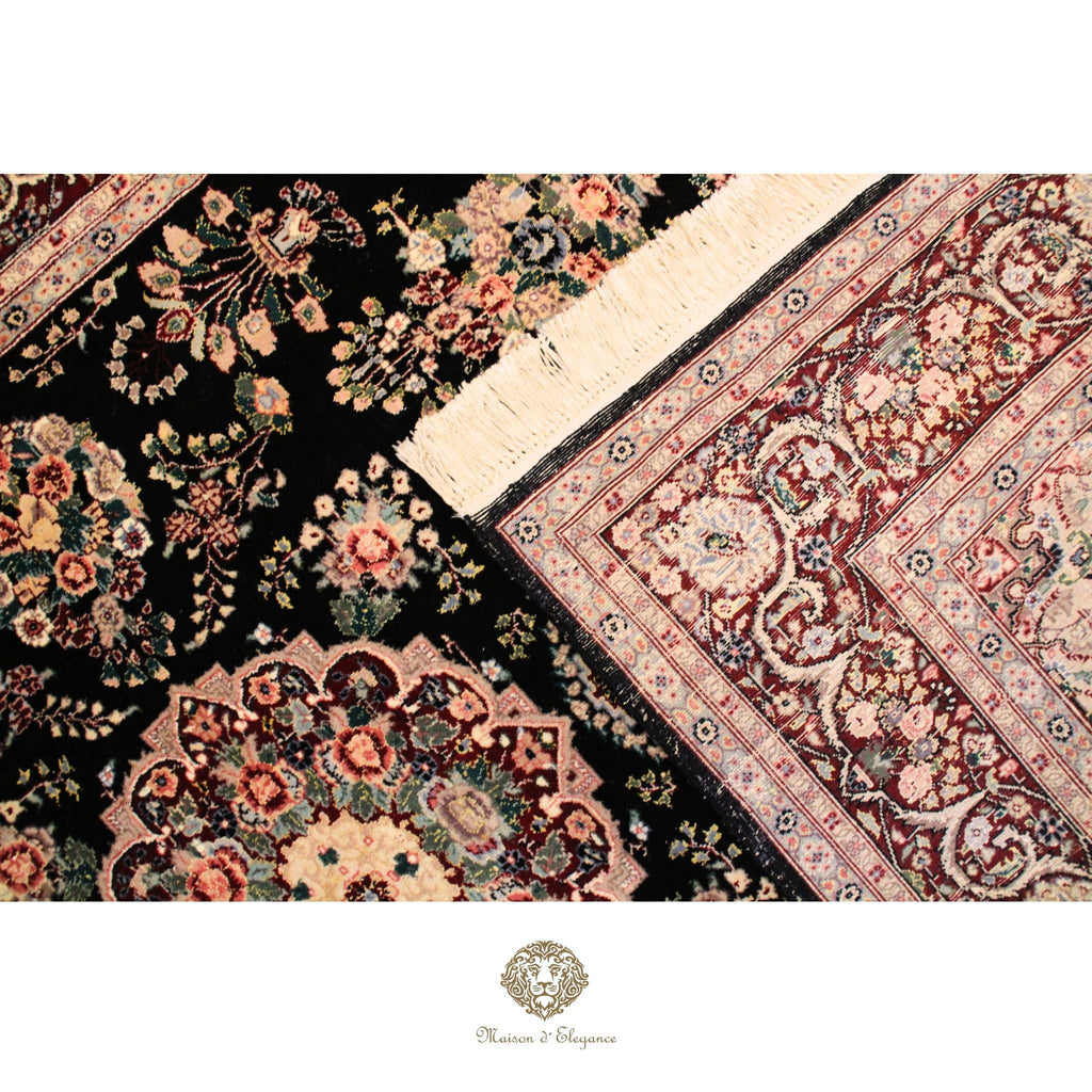 Close-up of intricately designed floral-patterned rugs with a brand logo at the bottom.
