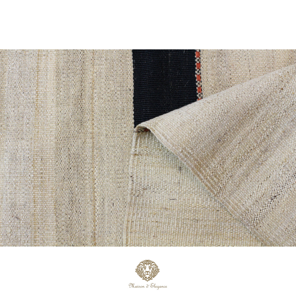 Close-up of a textured fabric with a brand logo at the bottom right corner.
