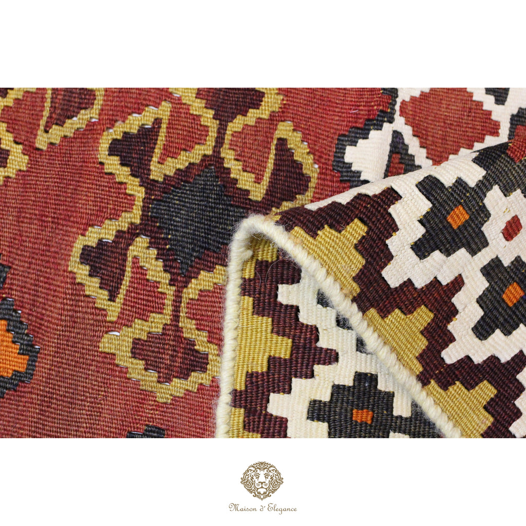 Close-up of two patterned rugs with a brand logo at the bottom.