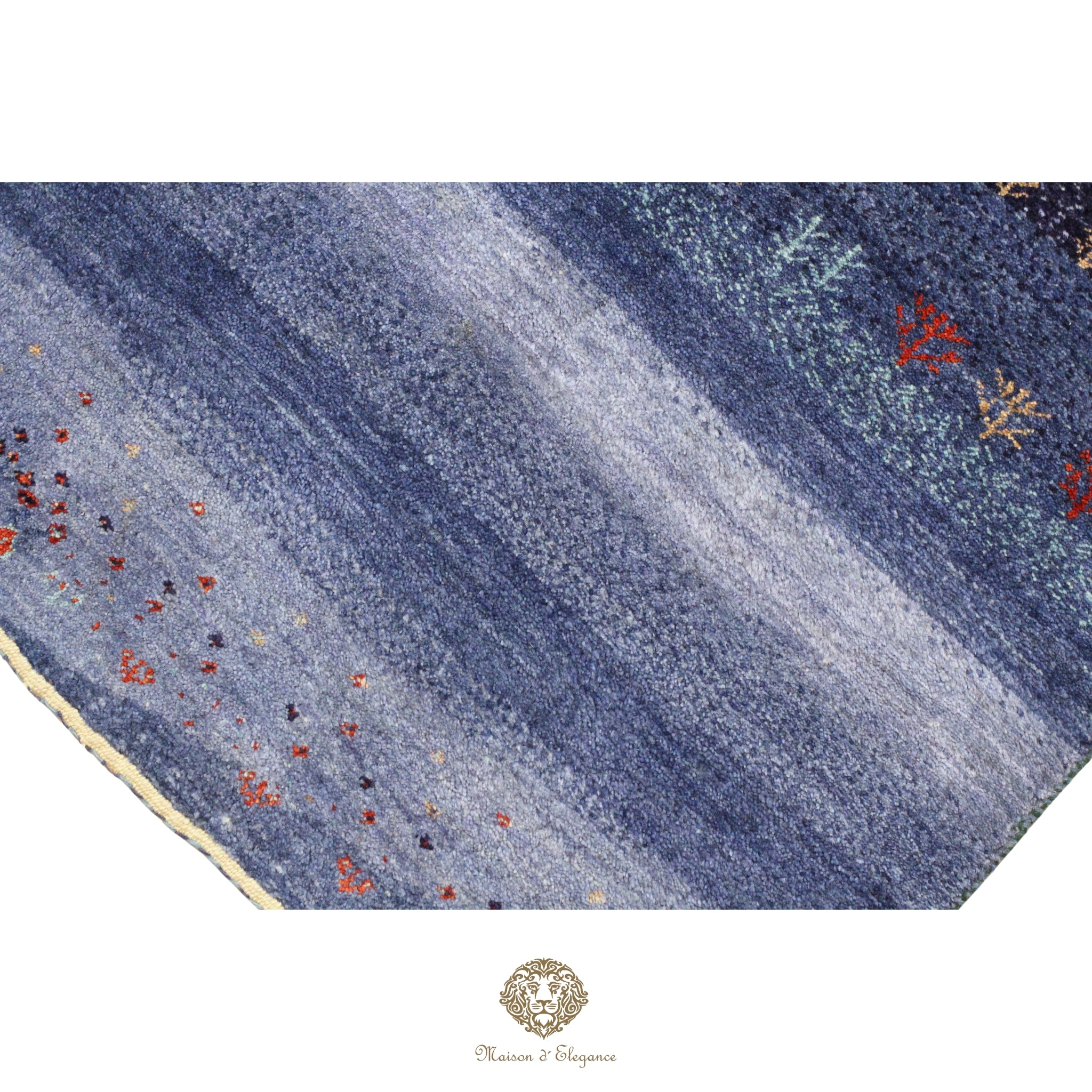 Close-up of a blue textured rug with floral patterns on a white background