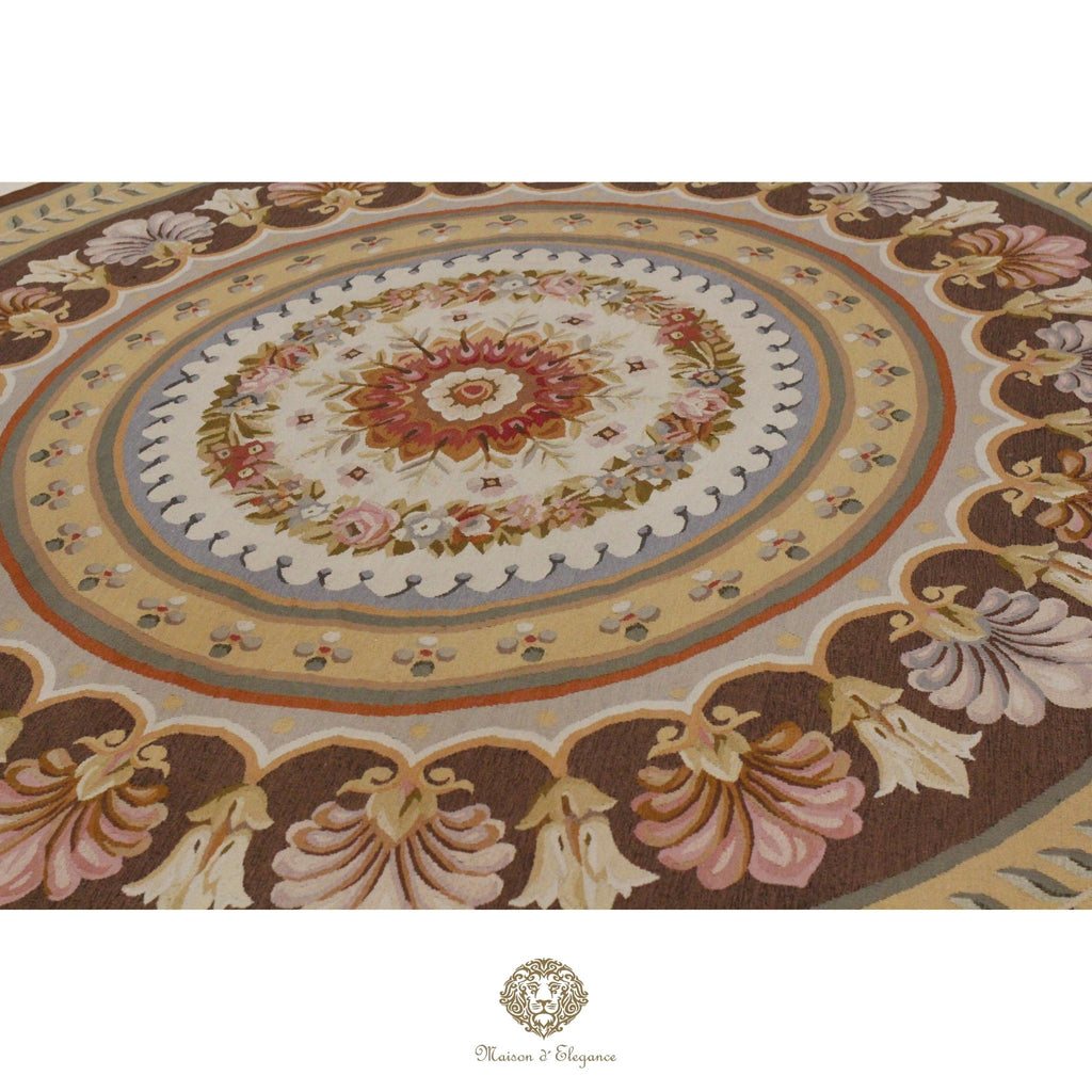 Decorative French Aubusson with floral patterns and a central medallion on a brown background.