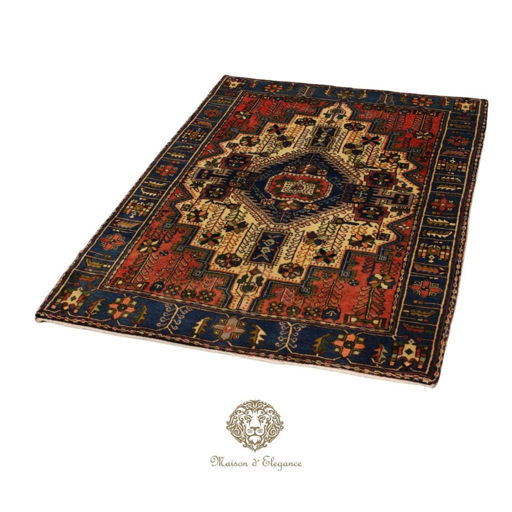 Decorative rug with intricate patterns on a white background, featuring the brand 'Maison d'Elegance'.