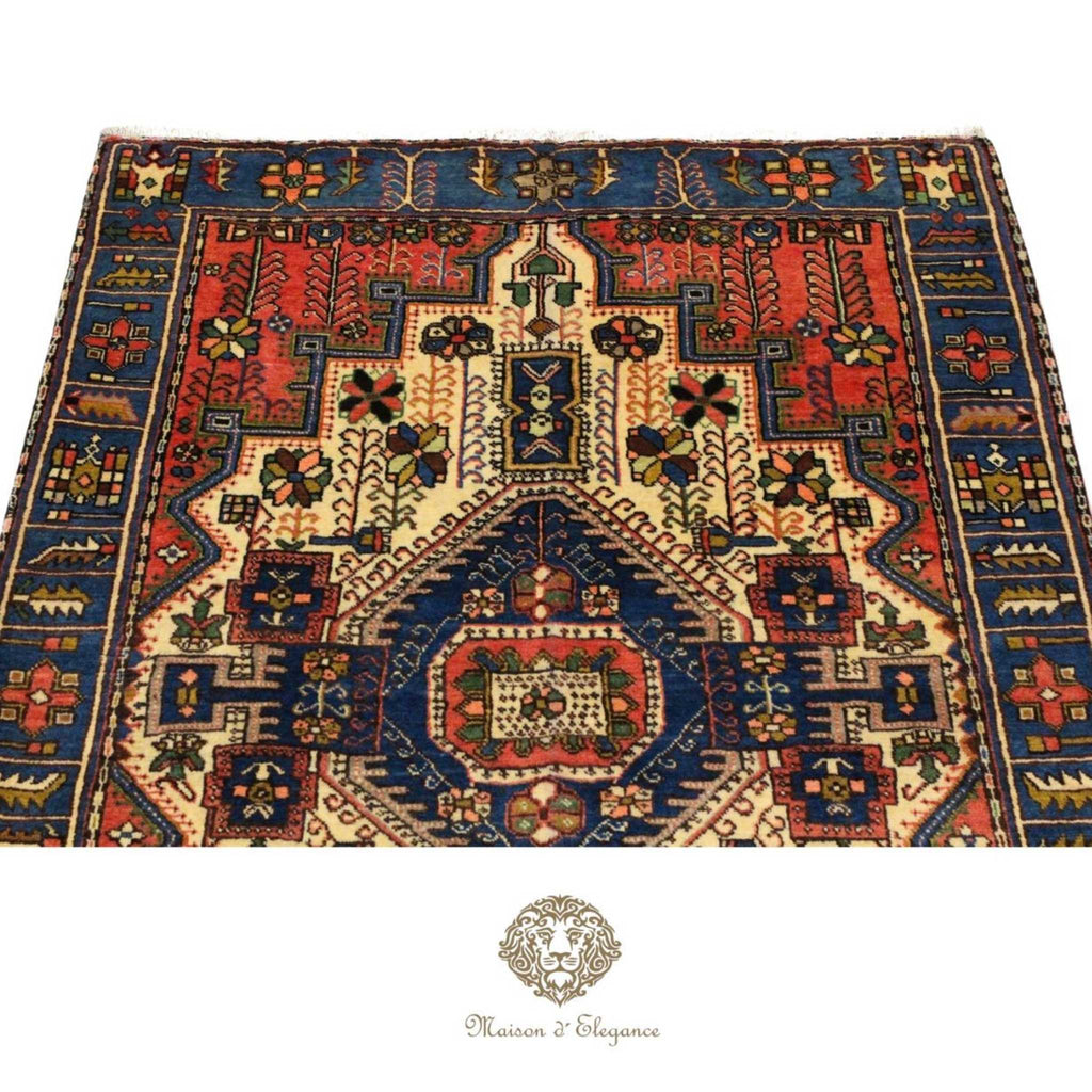 Decorative rug with intricate patterns on a white background, featuring the Maison d'Elegance logo.