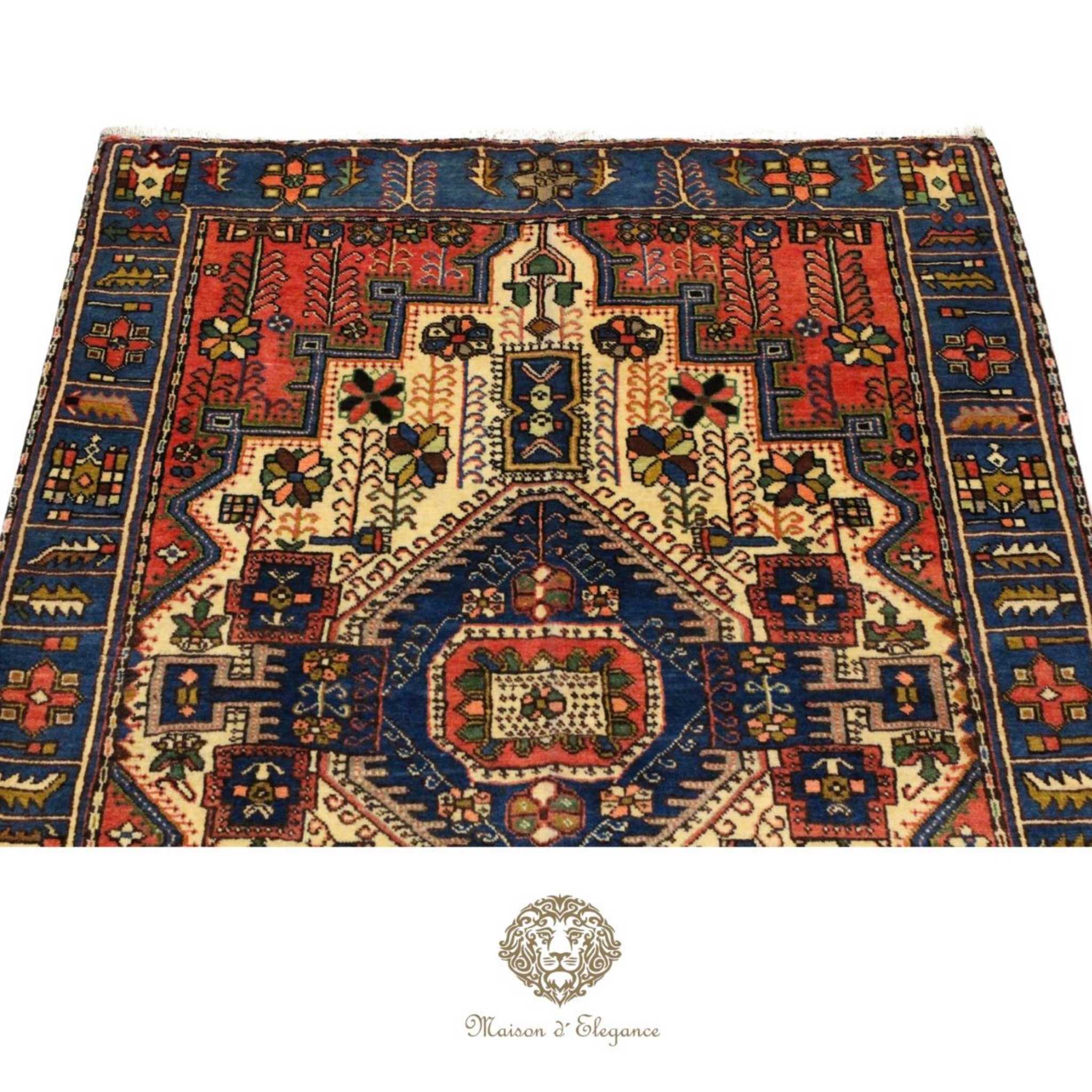 Decorative rug with intricate patterns on a white background, featuring the Maison d'Elegance logo.