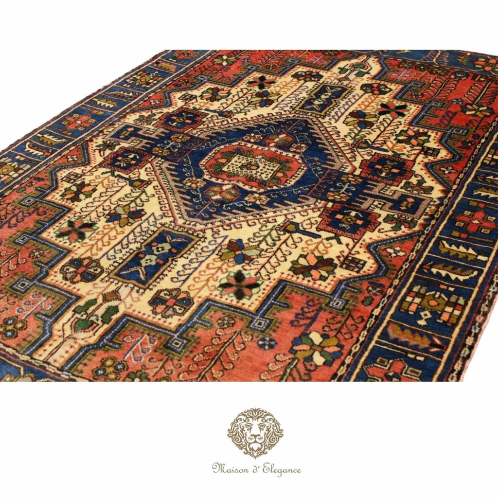 Decorative rug with intricate patterns on a white background, featuring the brand 'Maison d'Elegance'.