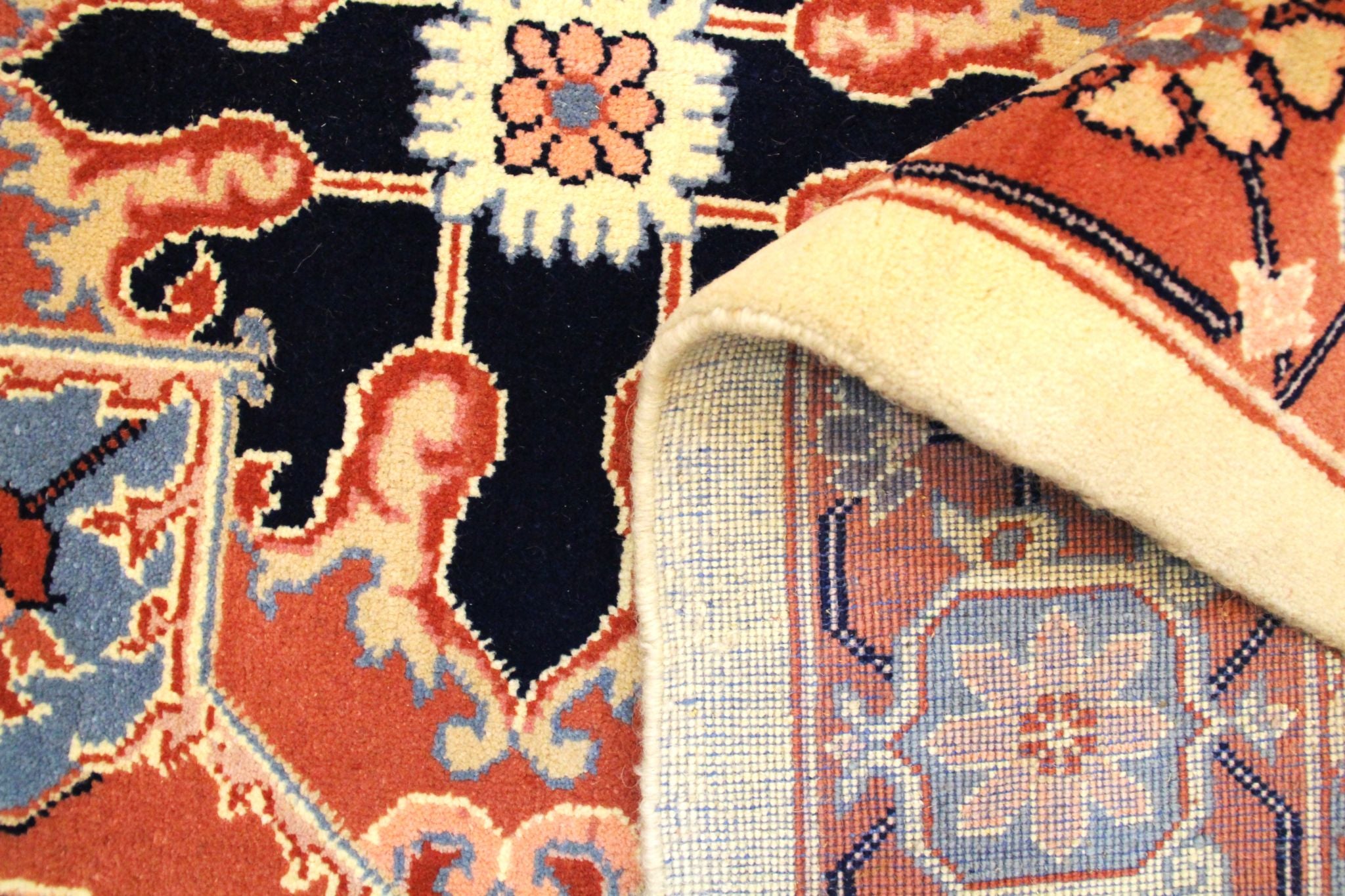 Close-up of a patterned rug with intricate designs and colors.