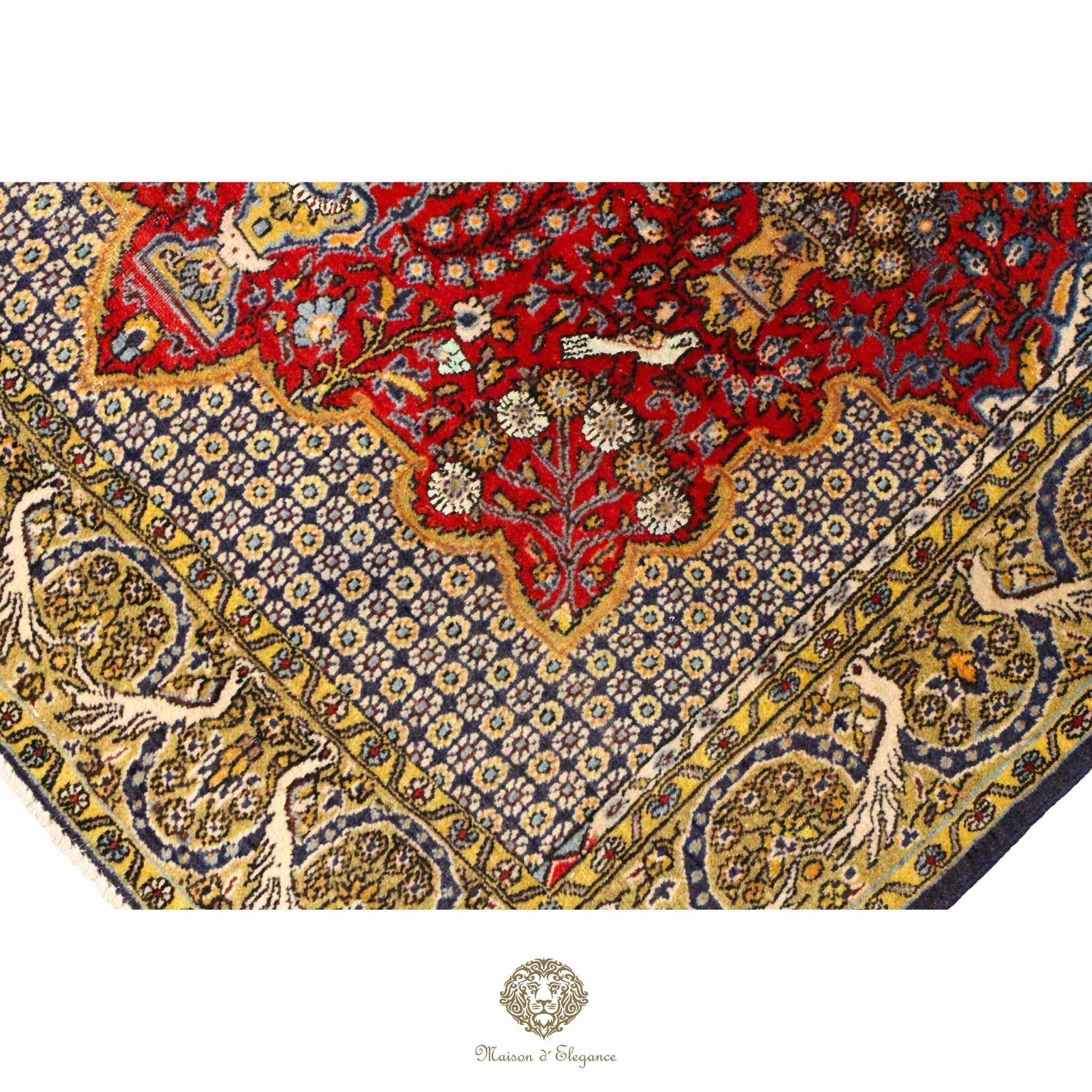 Close-up of a patterned fabric with intricate designs in red, blue, and gold.
