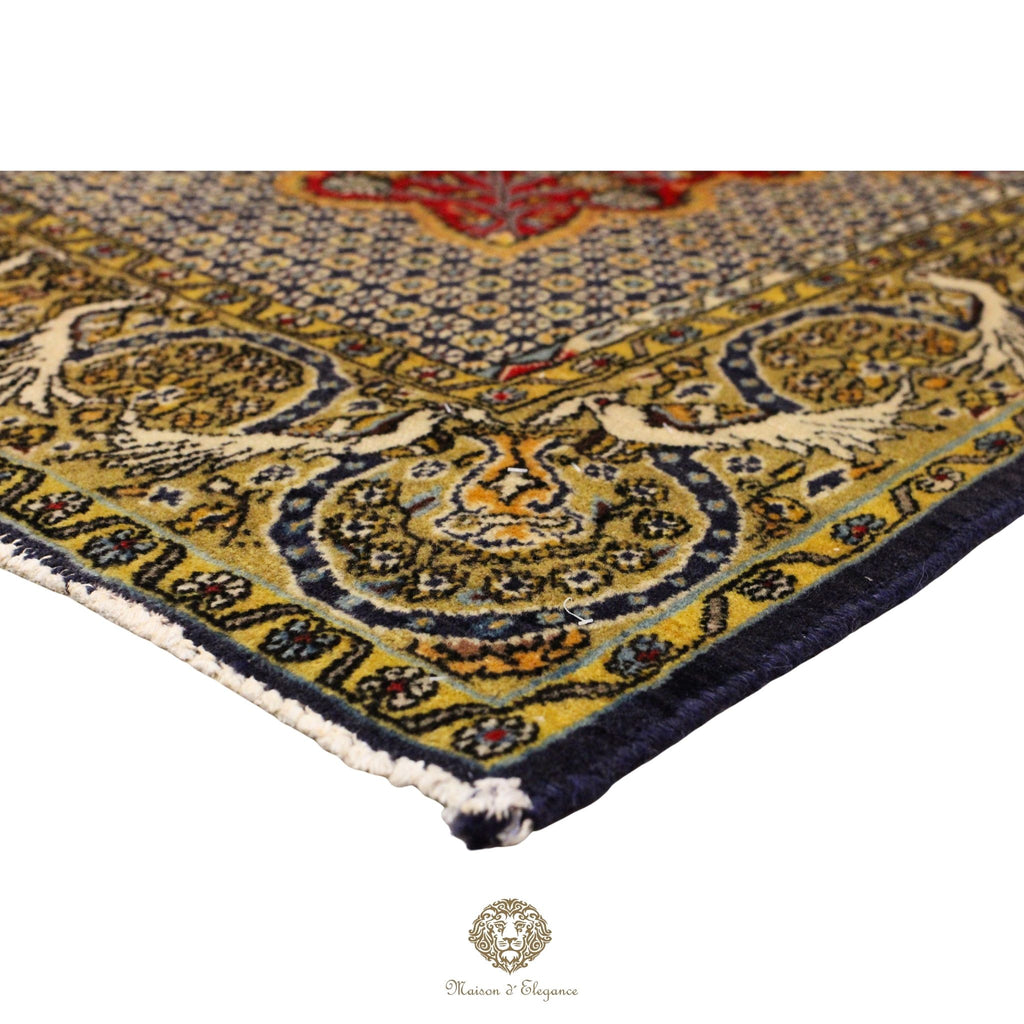 Close-up of a patterned rug with intricate designs on a red background