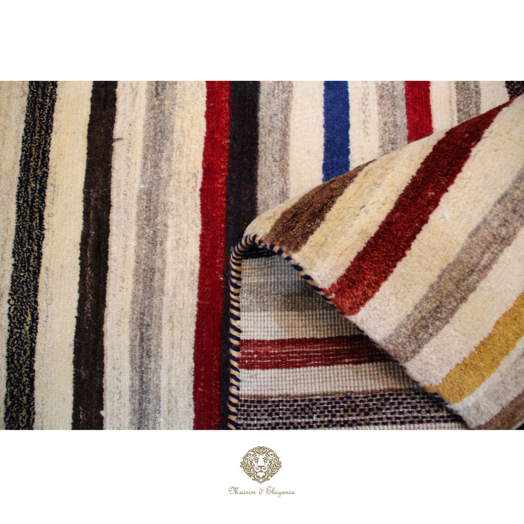 Striped fabric with a mix of colors including red, blue, and beige, displayed on a white background.