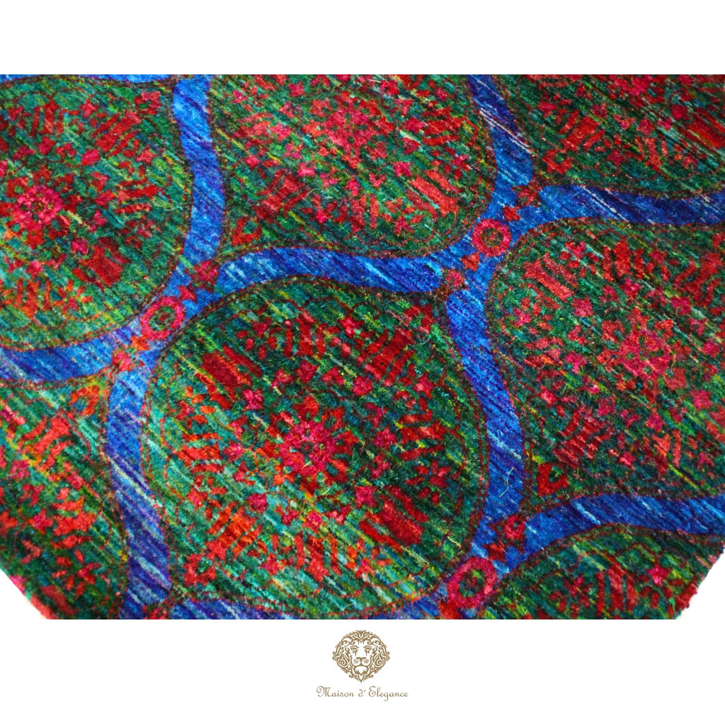 Close-up of a textured fabric with red and blue patterns, brand 'Cherish & Treasure' visible.