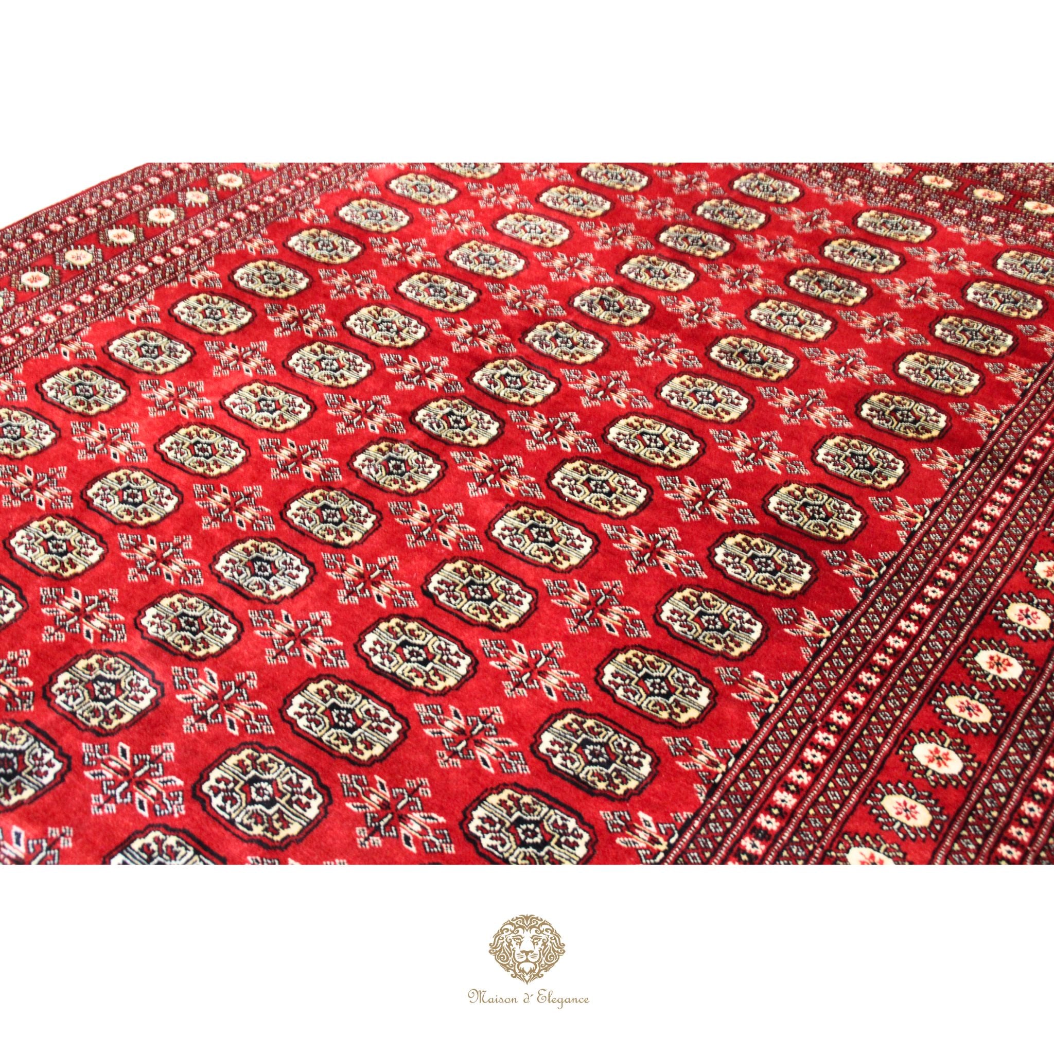 Red patterned fabric with intricate designs on a white background