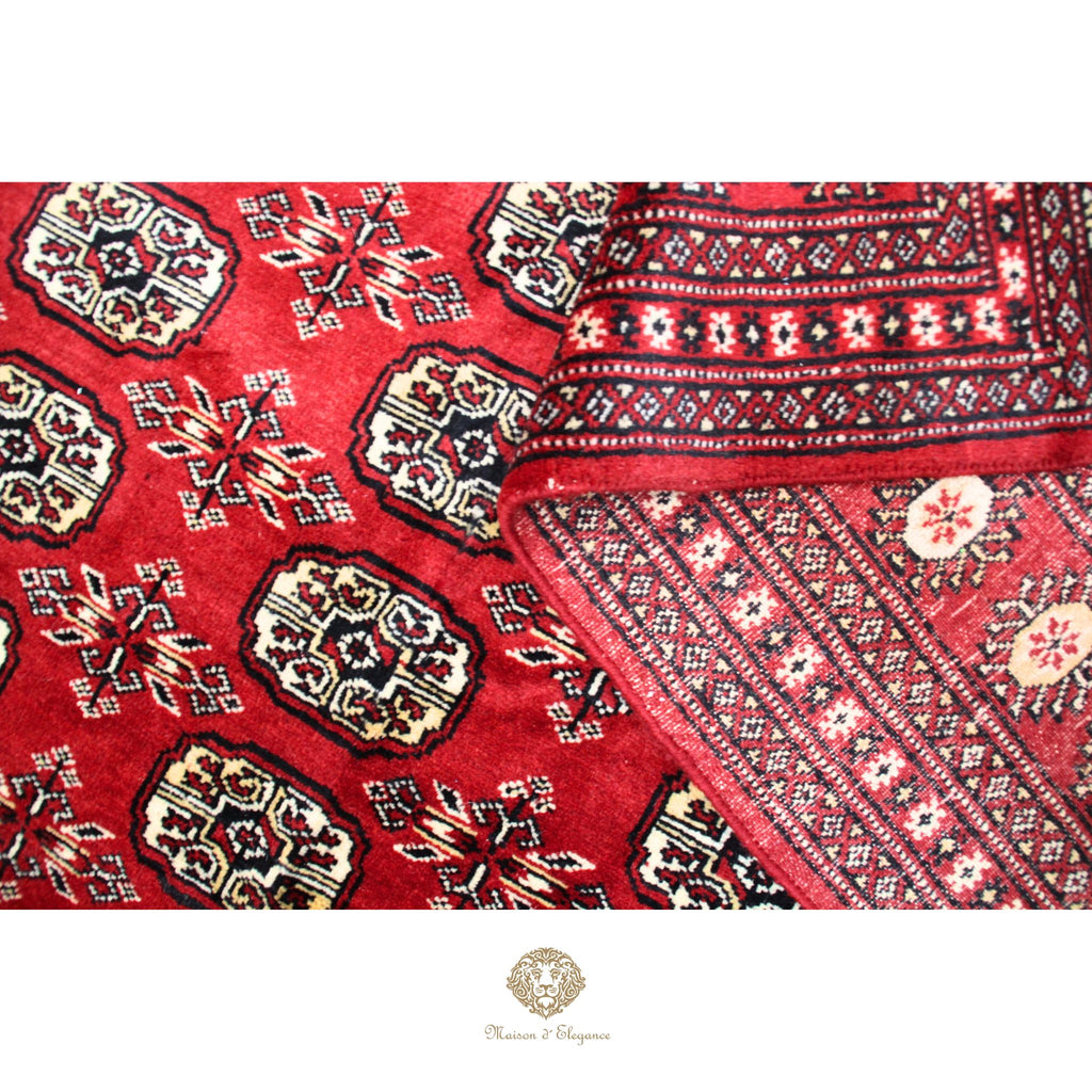 Close-up of a red patterned fabric with intricate designs