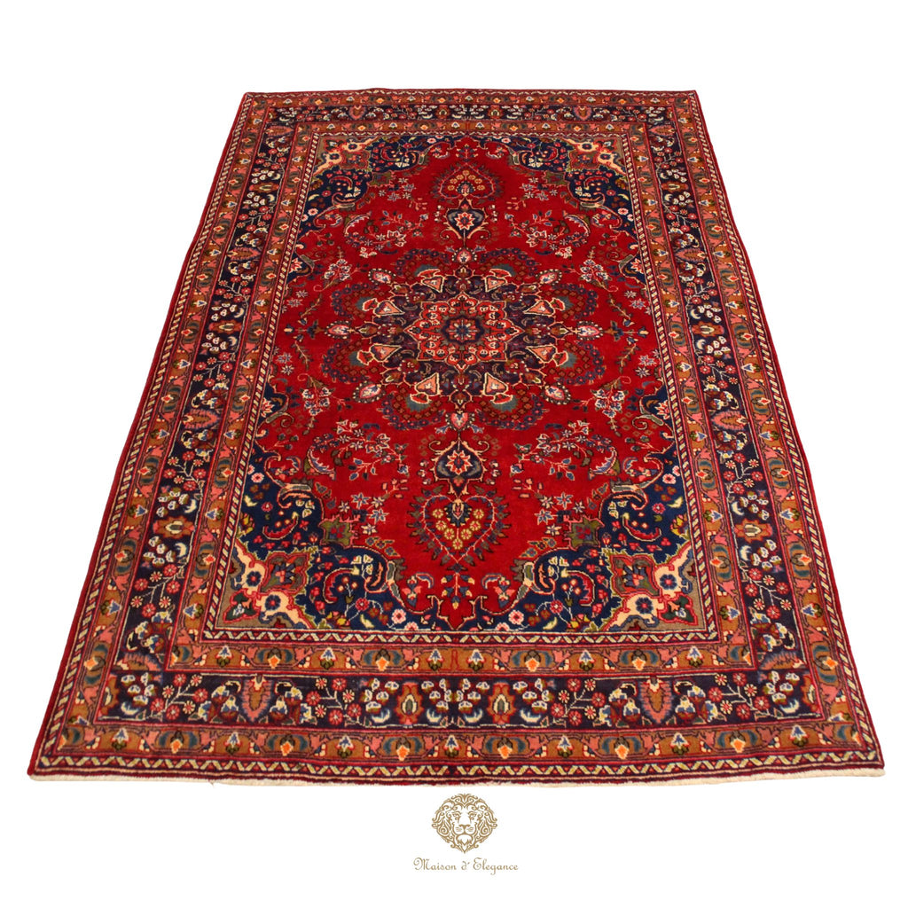 Decorative red rug with intricate patterns on a white background