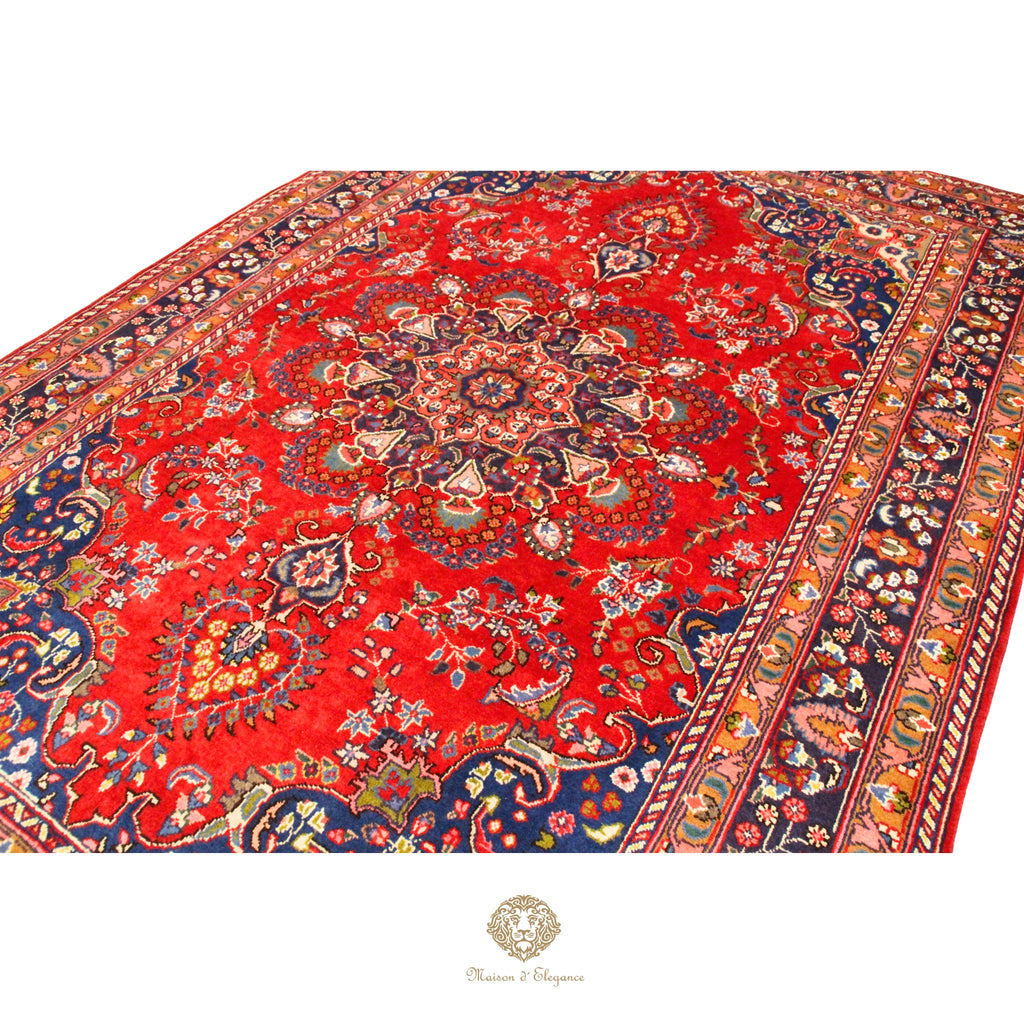 Decorative red rug with intricate patterns on a white background