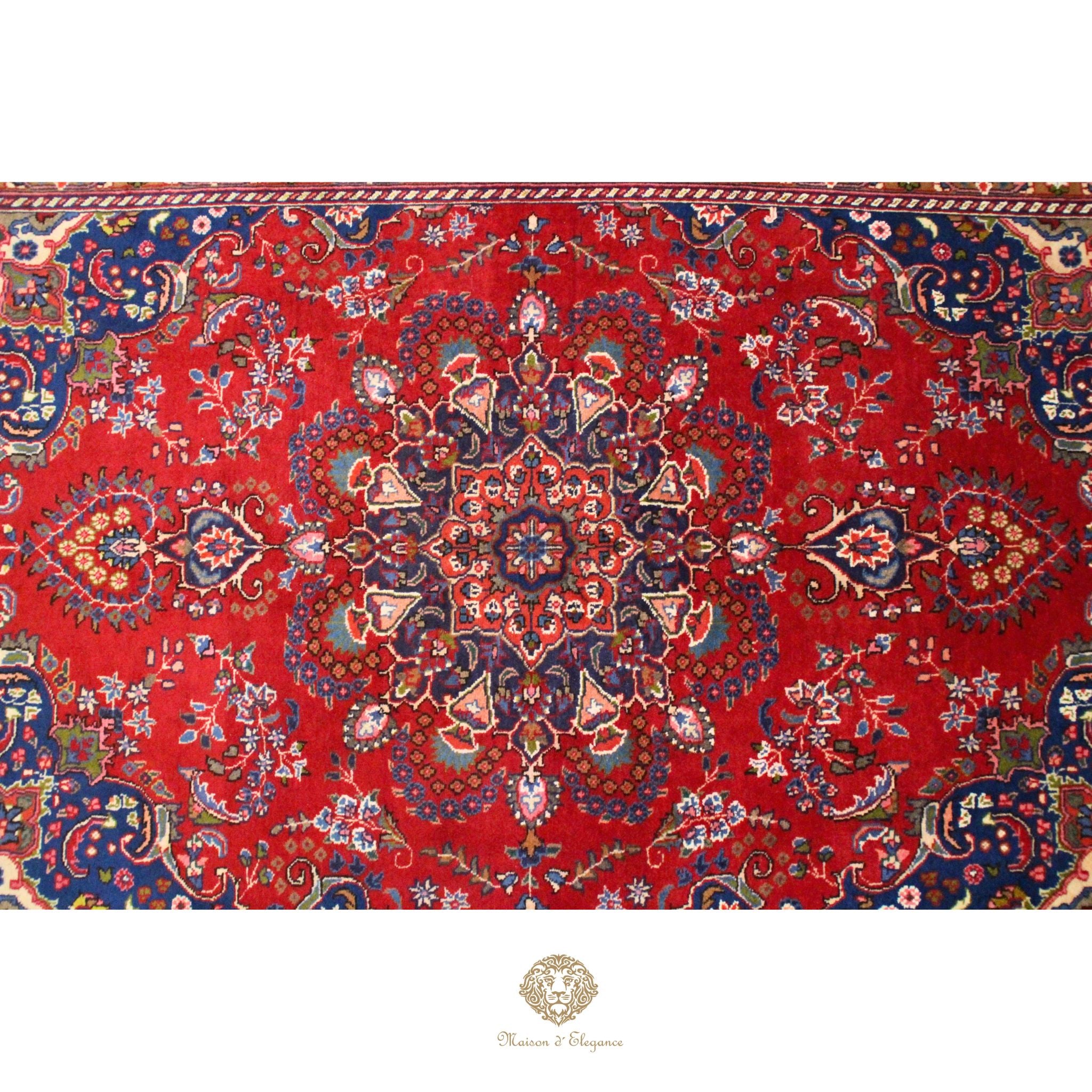 Decorative red rug with intricate paisley patterns on a white background