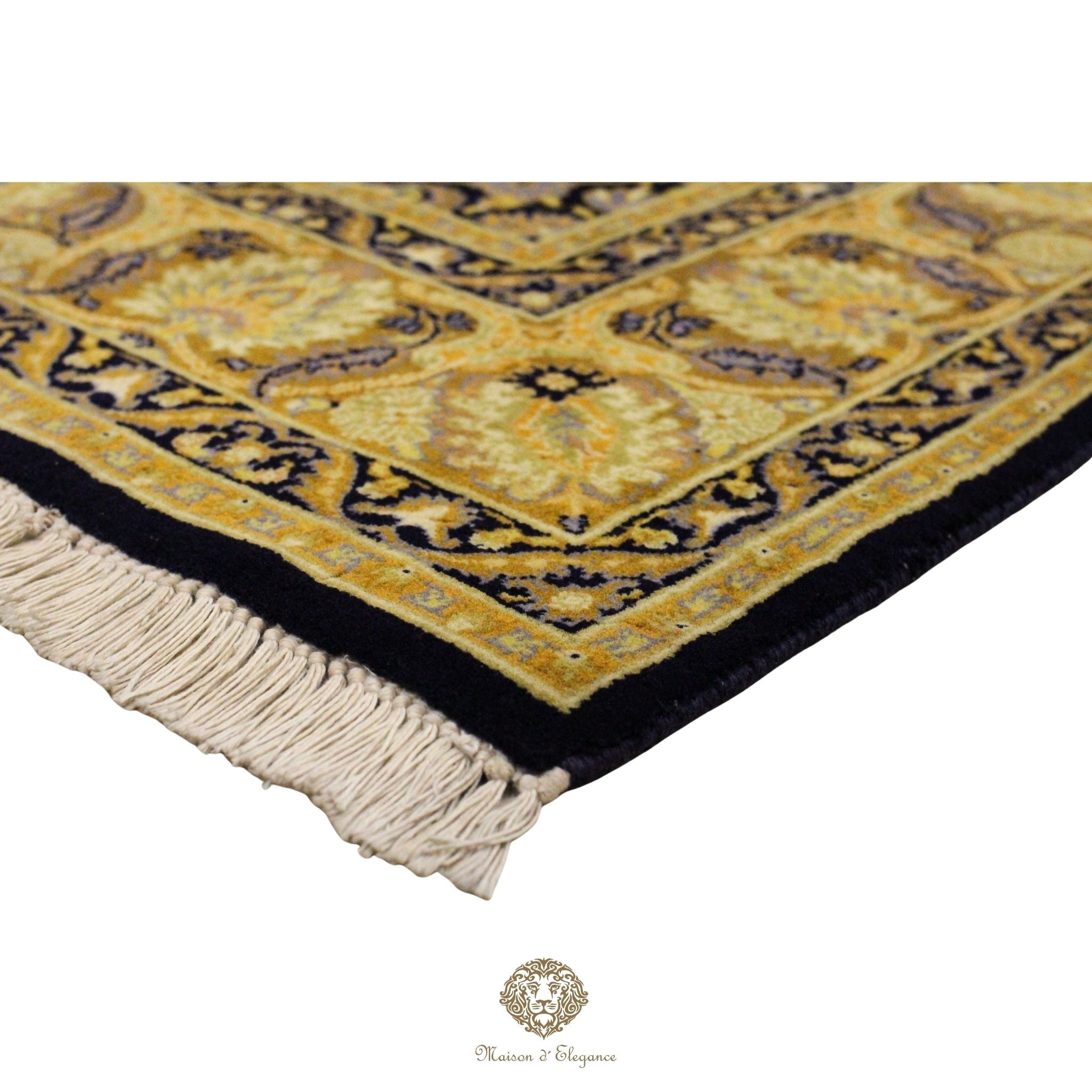 Close-up of a floral-patterned rug with a brand logo at the bottom.