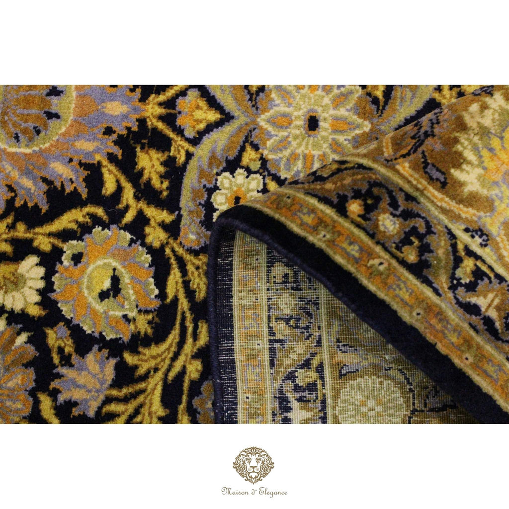 Close-up of a patterned rug with intricate designs on a navy background