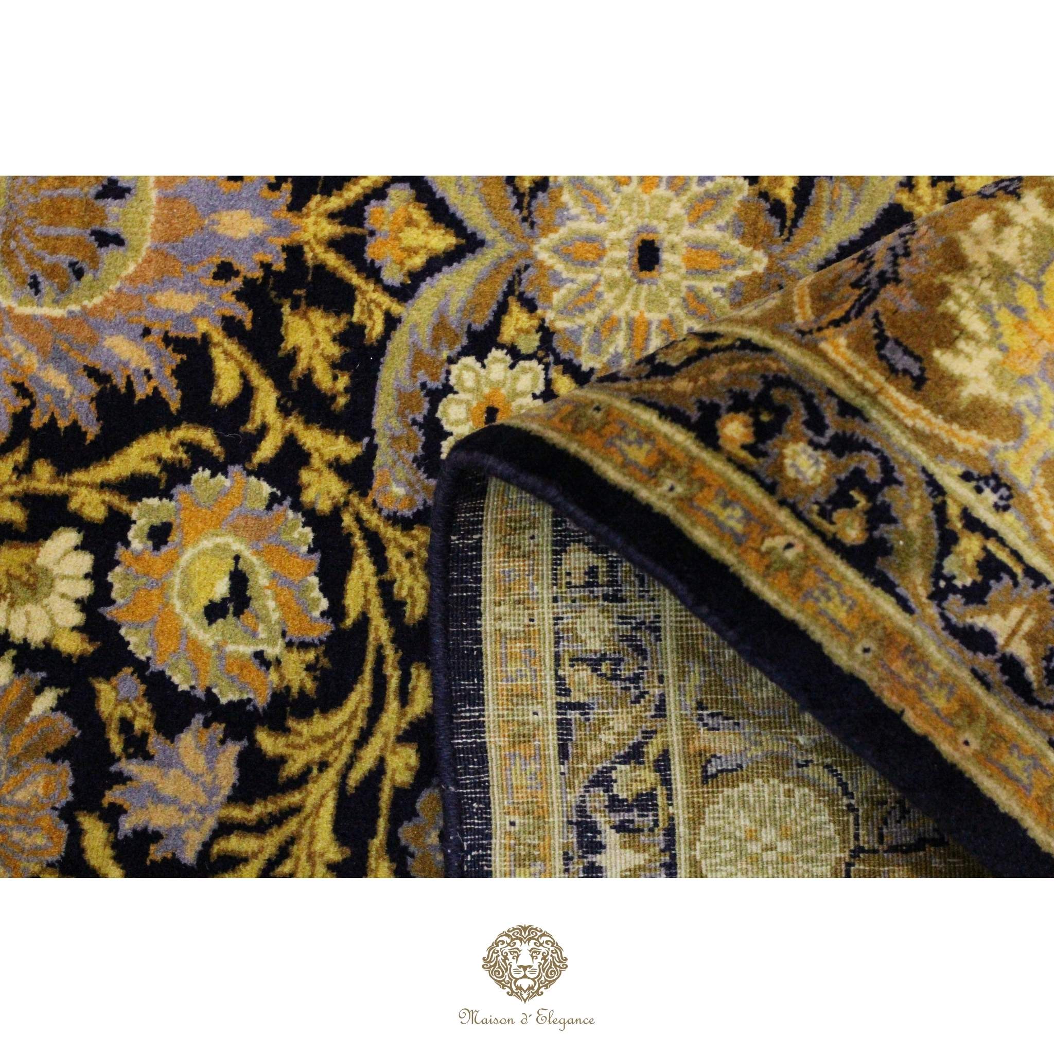 Close-up of a patterned rug with intricate designs on a navy background