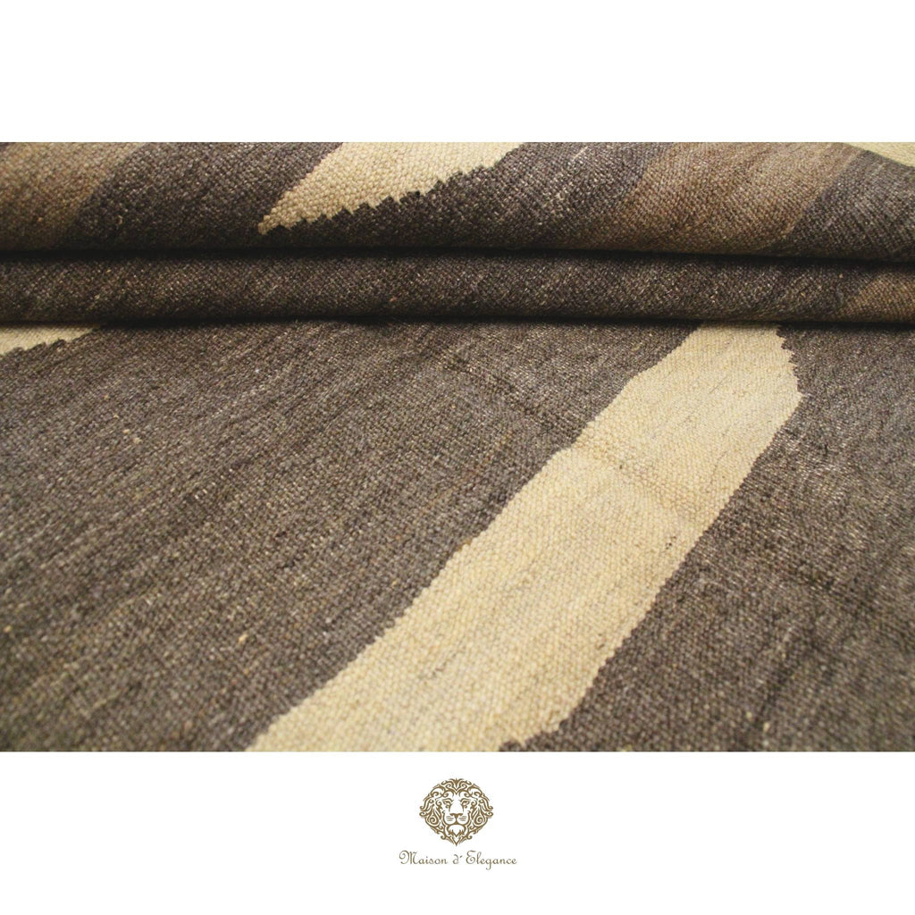 Brown and beige patterned fabric with a brand logo at the bottom.