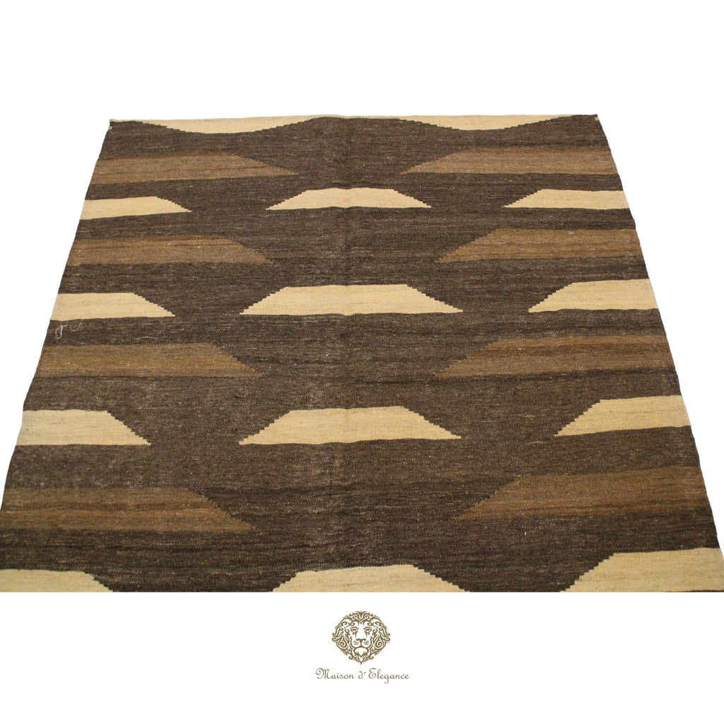 Brown and beige patterned rug on a brown background
