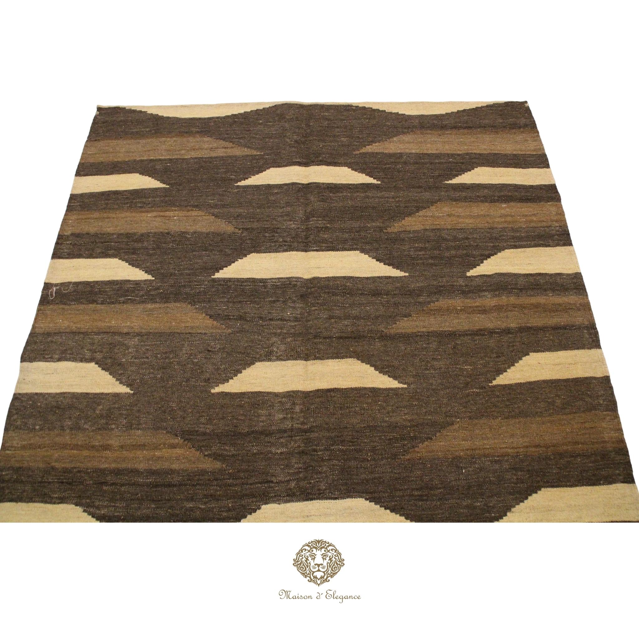 Brown and beige patterned rug on a brown background
