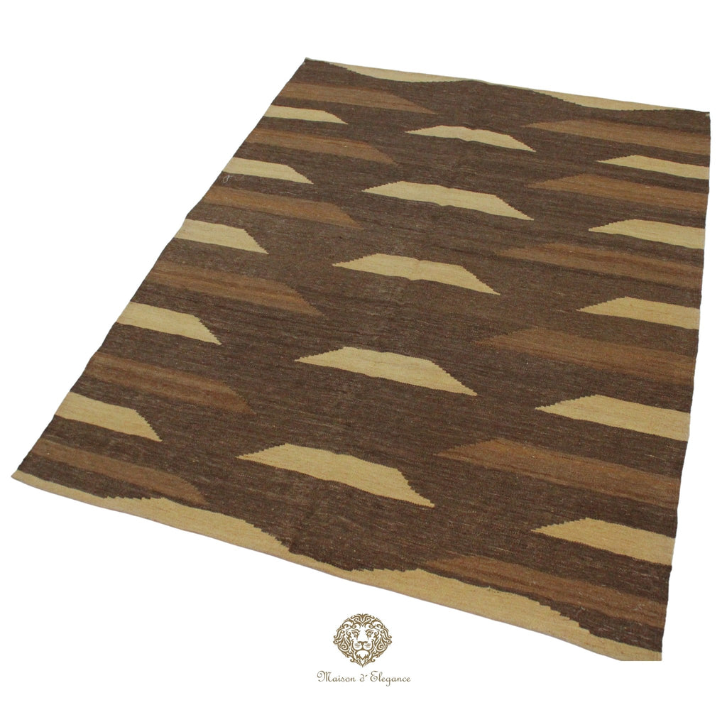 Brown and beige patterned rug on a brown background