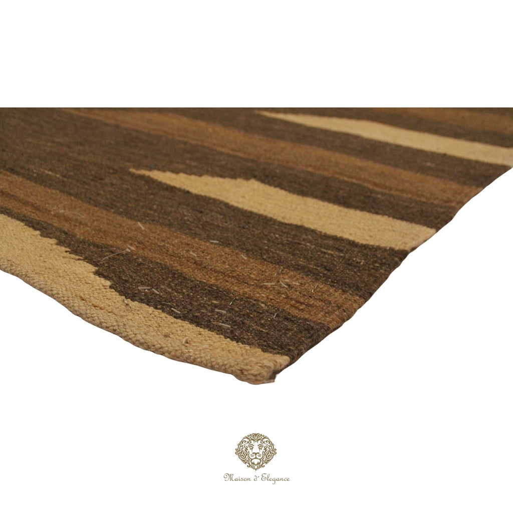 Striped brown and beige rug on a brown background