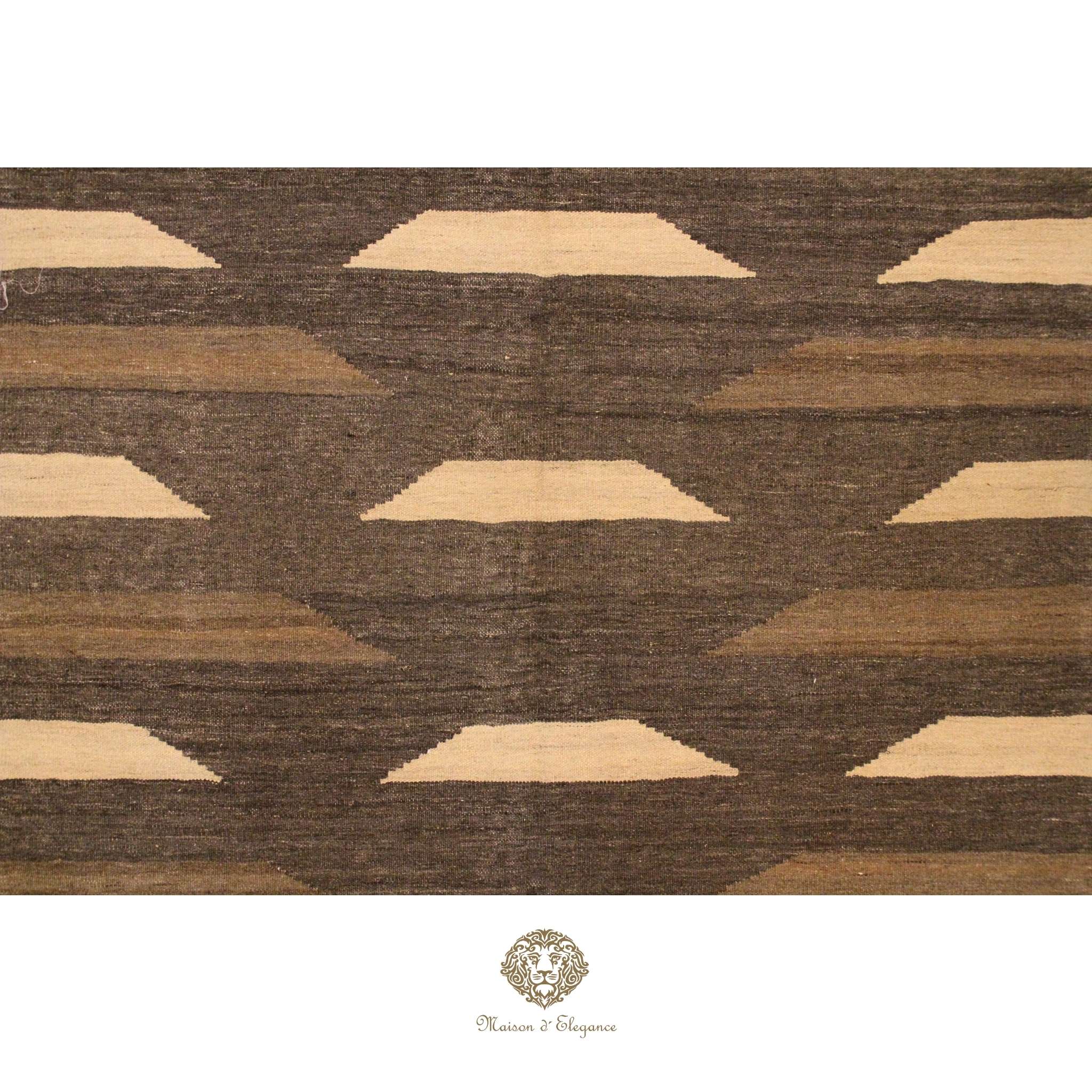 Patterned rug with geometric design in brown and beige on a brown background, featuring a brand logo.