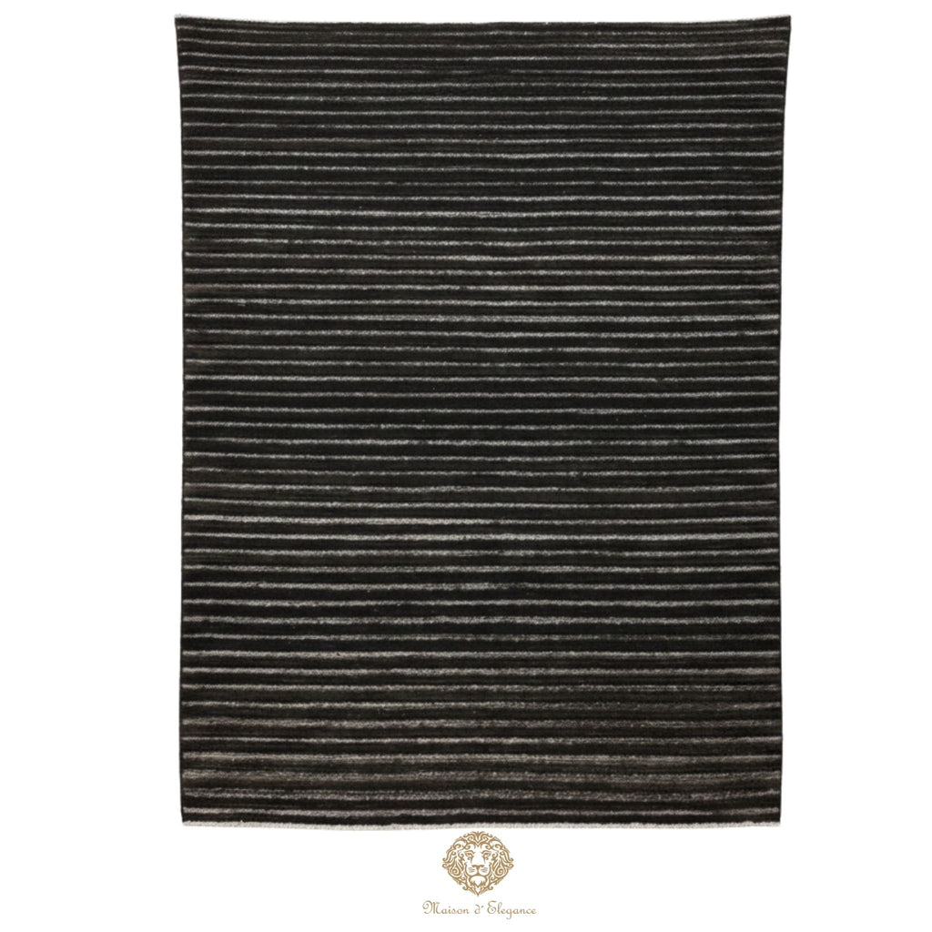 Striped black and gray rug on a white background