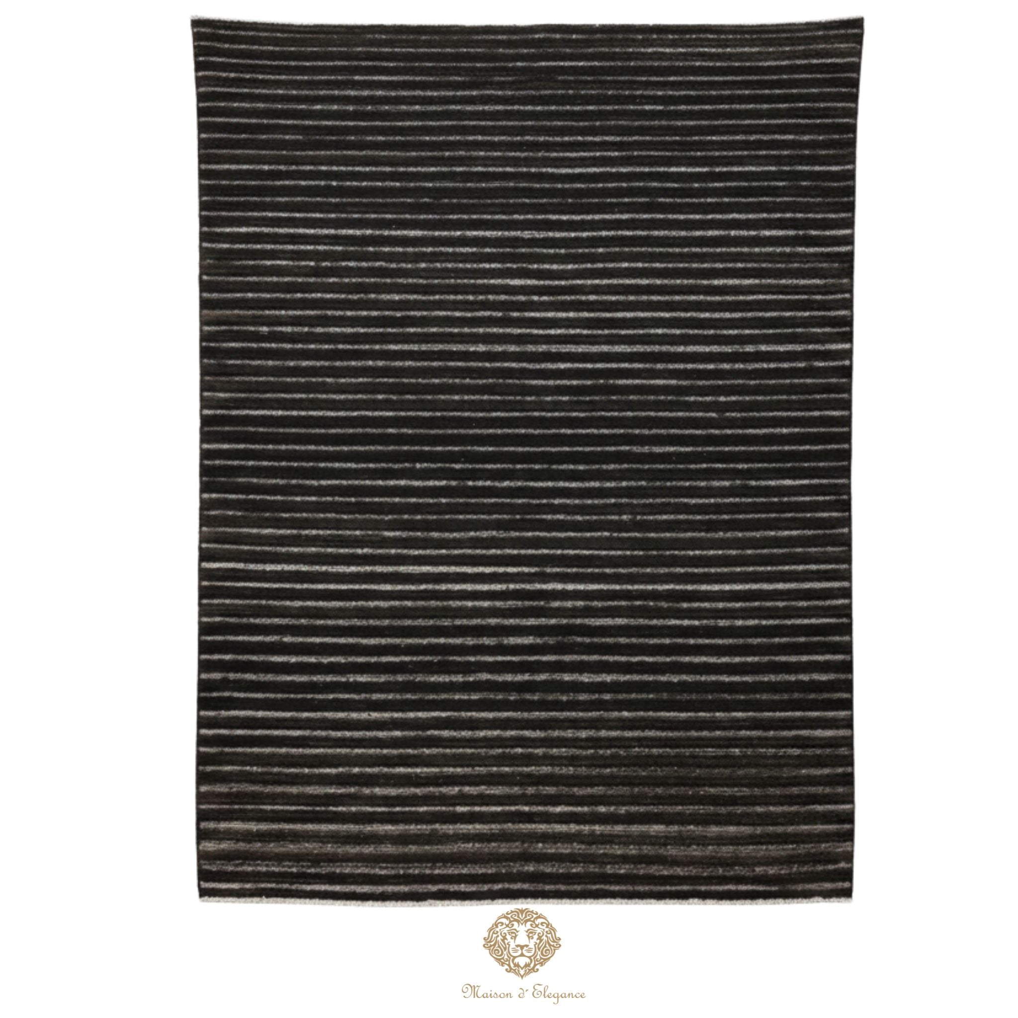 Striped black and gray rug on a white background