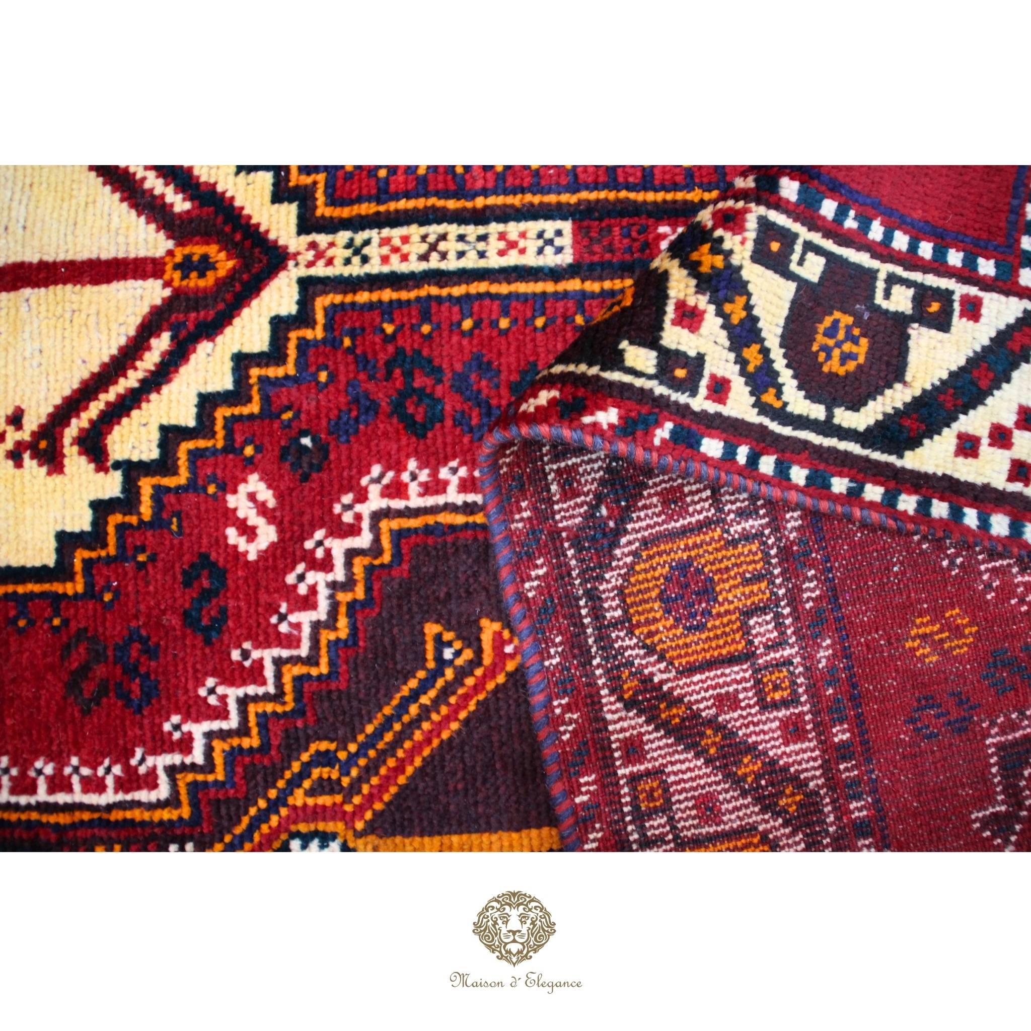 Close-up of intricately patterned rugs with a brand logo at the bottom.
