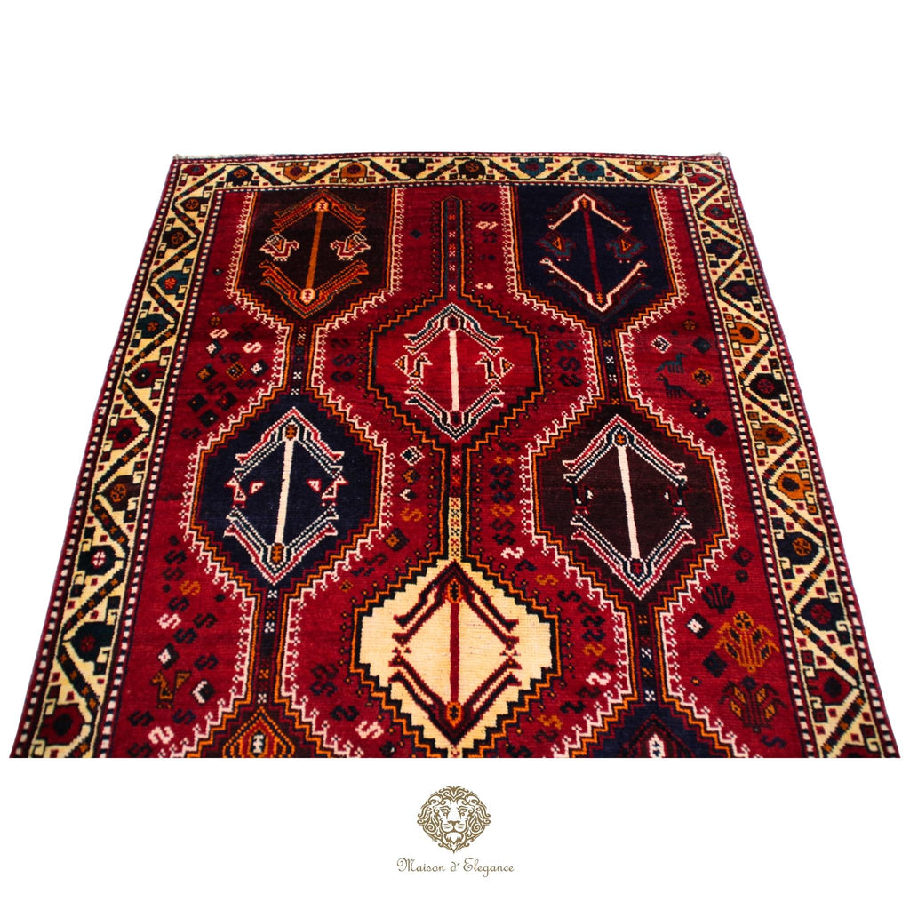 Decorative rug with geometric pattern on a red background